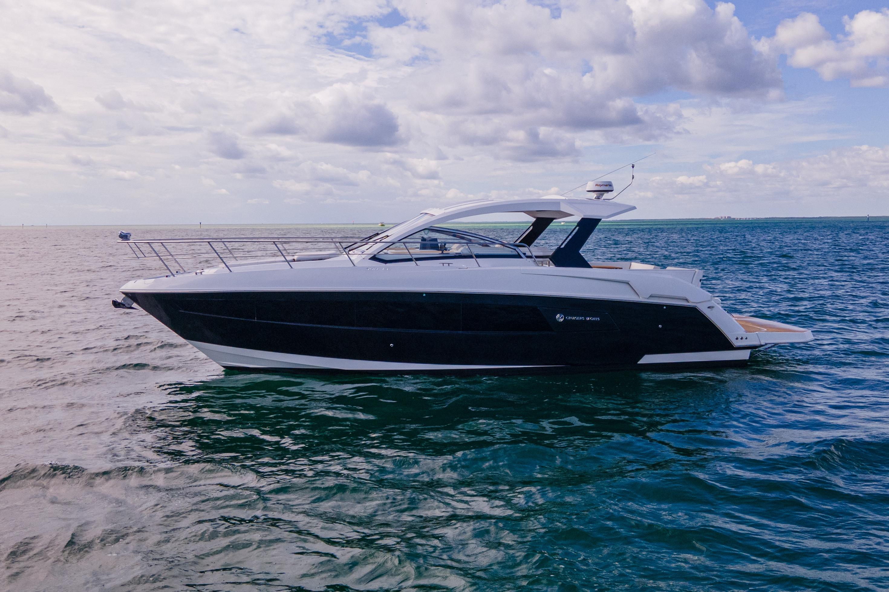 2018 Cruisers Yachts 390 Express Coupe on open water under cloudy sky.