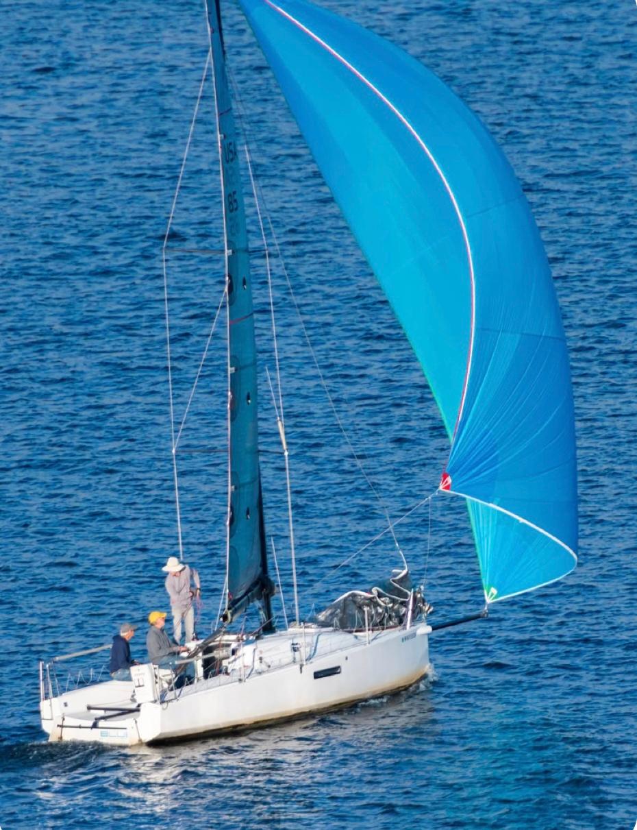 Sailboat Seascape 27, 2018 model, with blue spinnaker on open water.