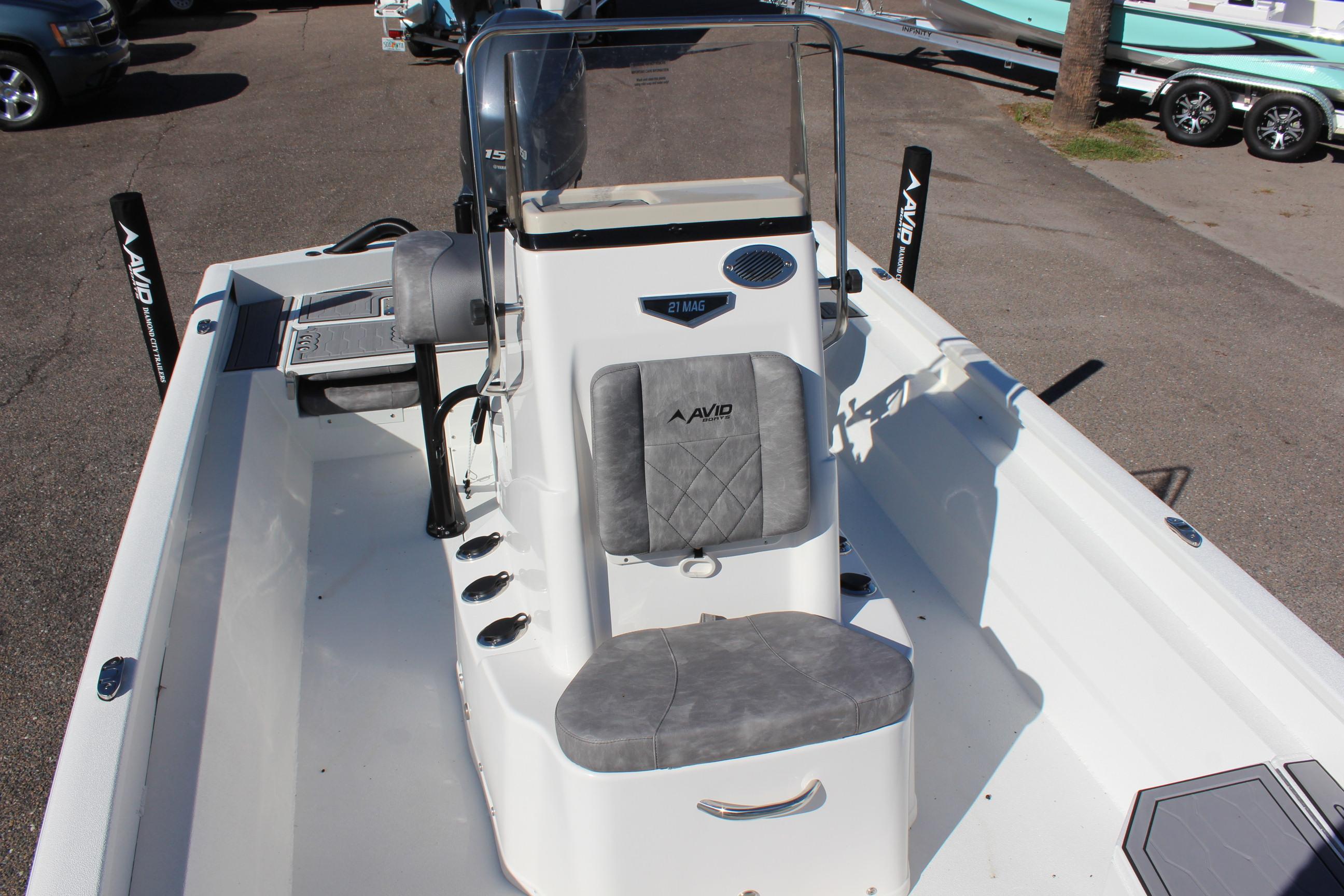 2023 Avid 21 Mag boat interior with console and seating.