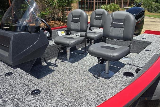 2026 Tracker Pro Guide V-16 SC boat interior with three gray seats and steering console.