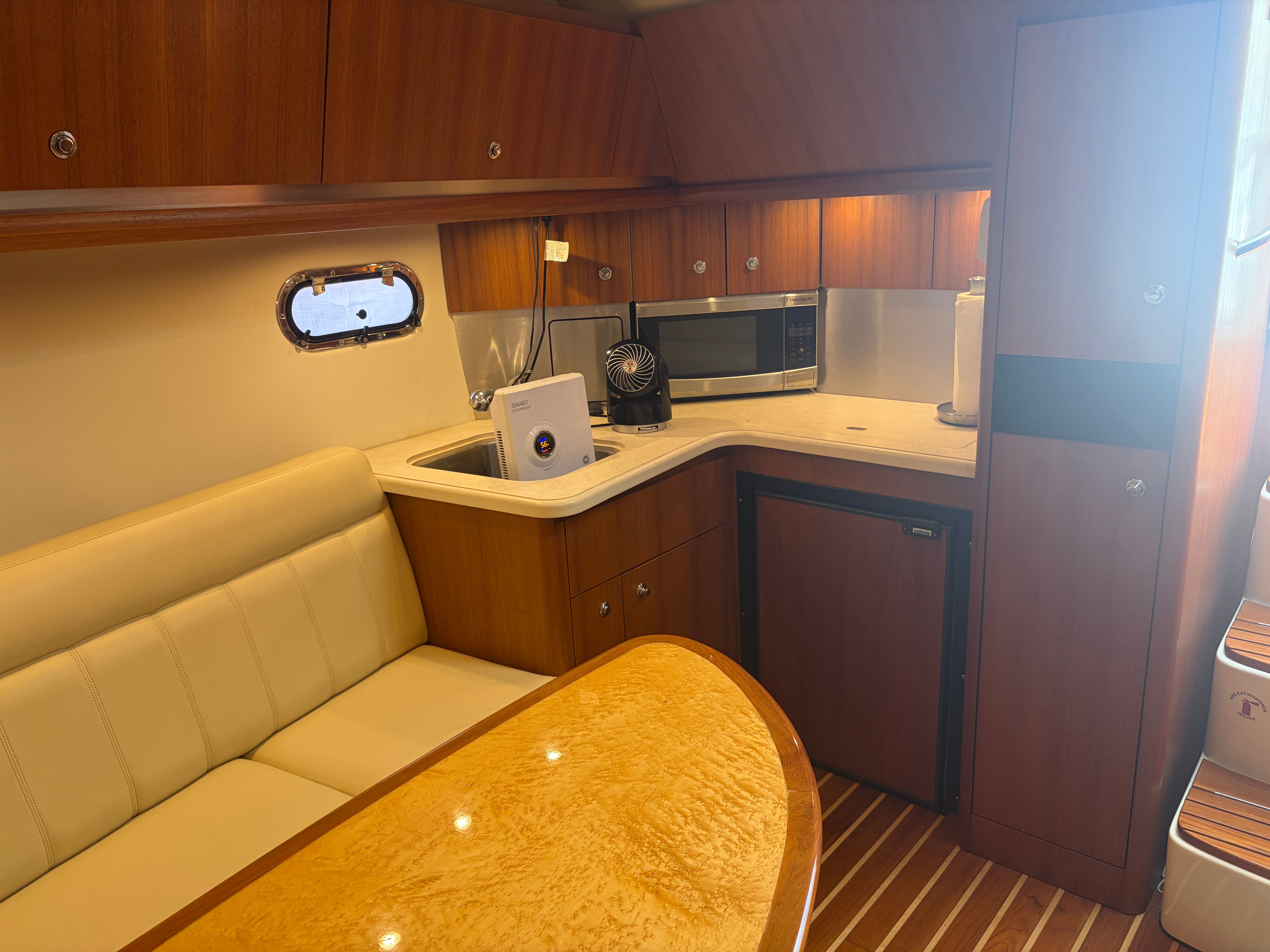 Interior of 2005 Tiara Yachts Sovran with kitchen and seating area.
