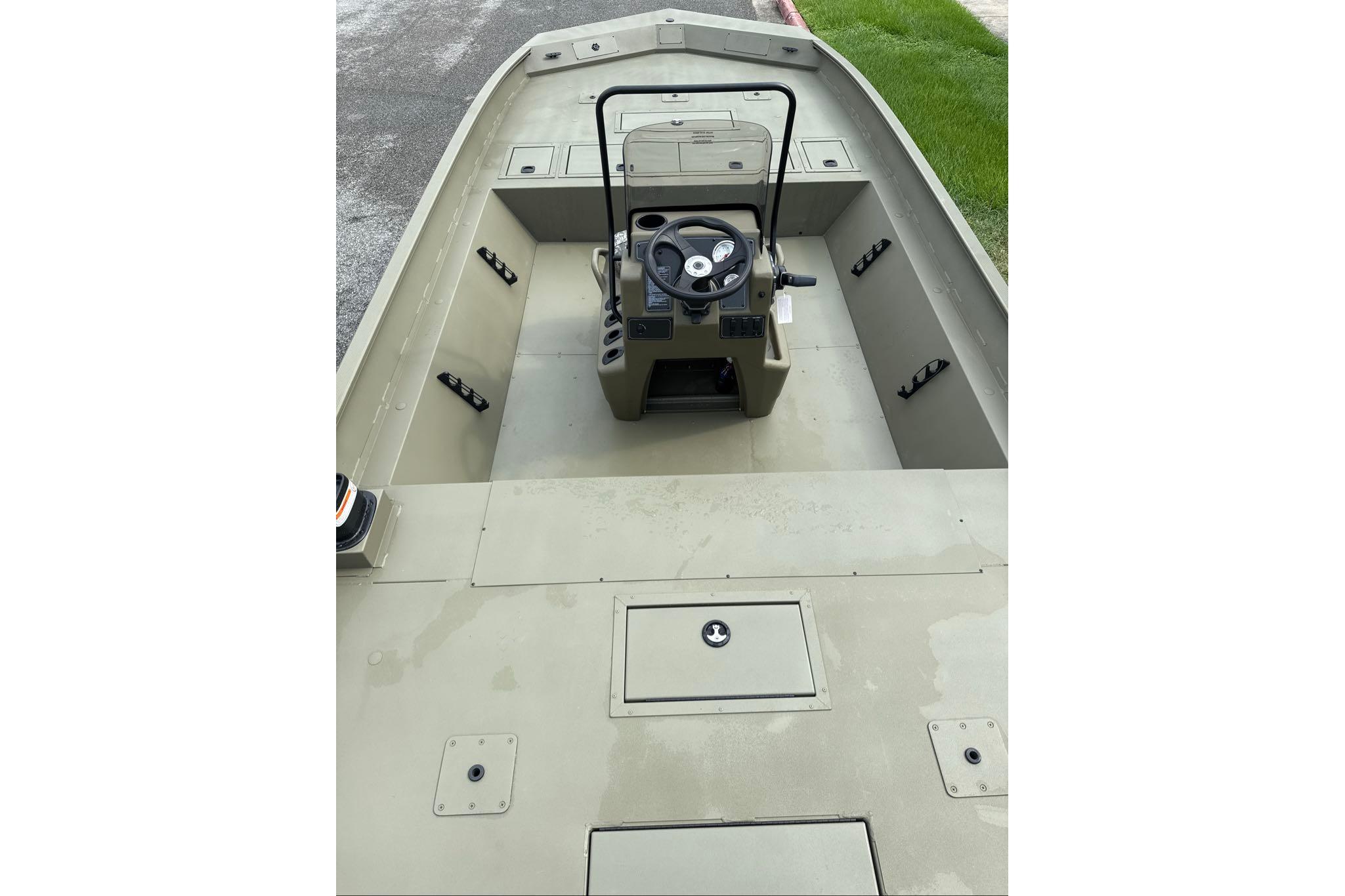 2026 Tracker Grizzly 2072 CC boat interior with center console and steering wheel.