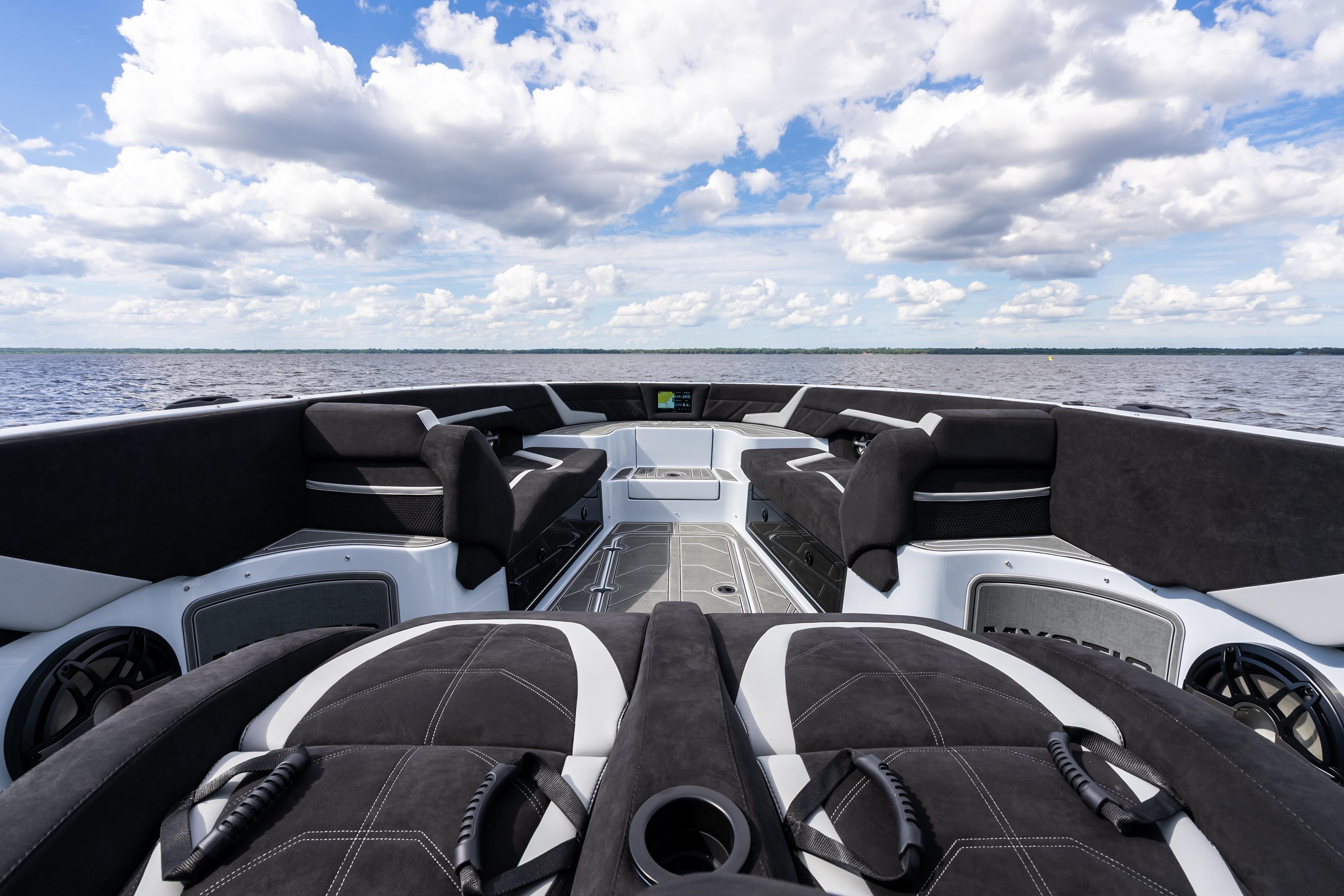 2027 Mystic Powerboats M4200 interior, showcasing luxurious seating and sleek design on open water.
