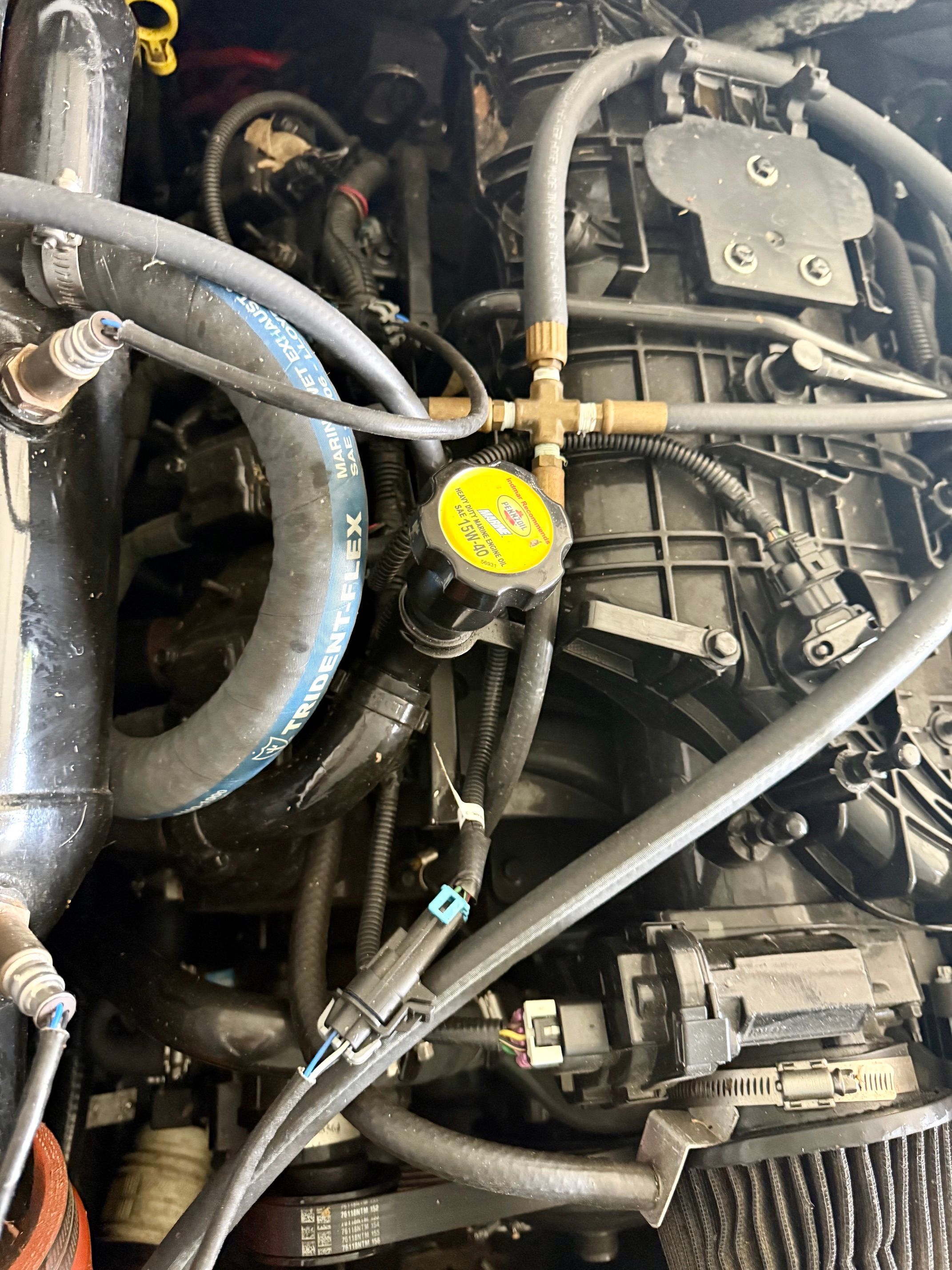 Close-up of a boat engine with hoses and wires.