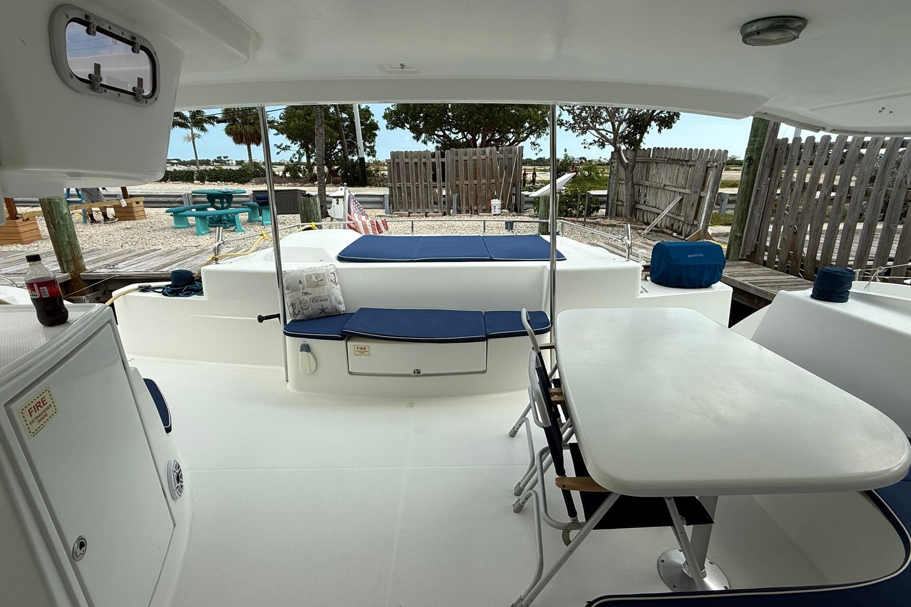 2008 Fountaine Pajot Salina 48 catamaran deck with seating and table.