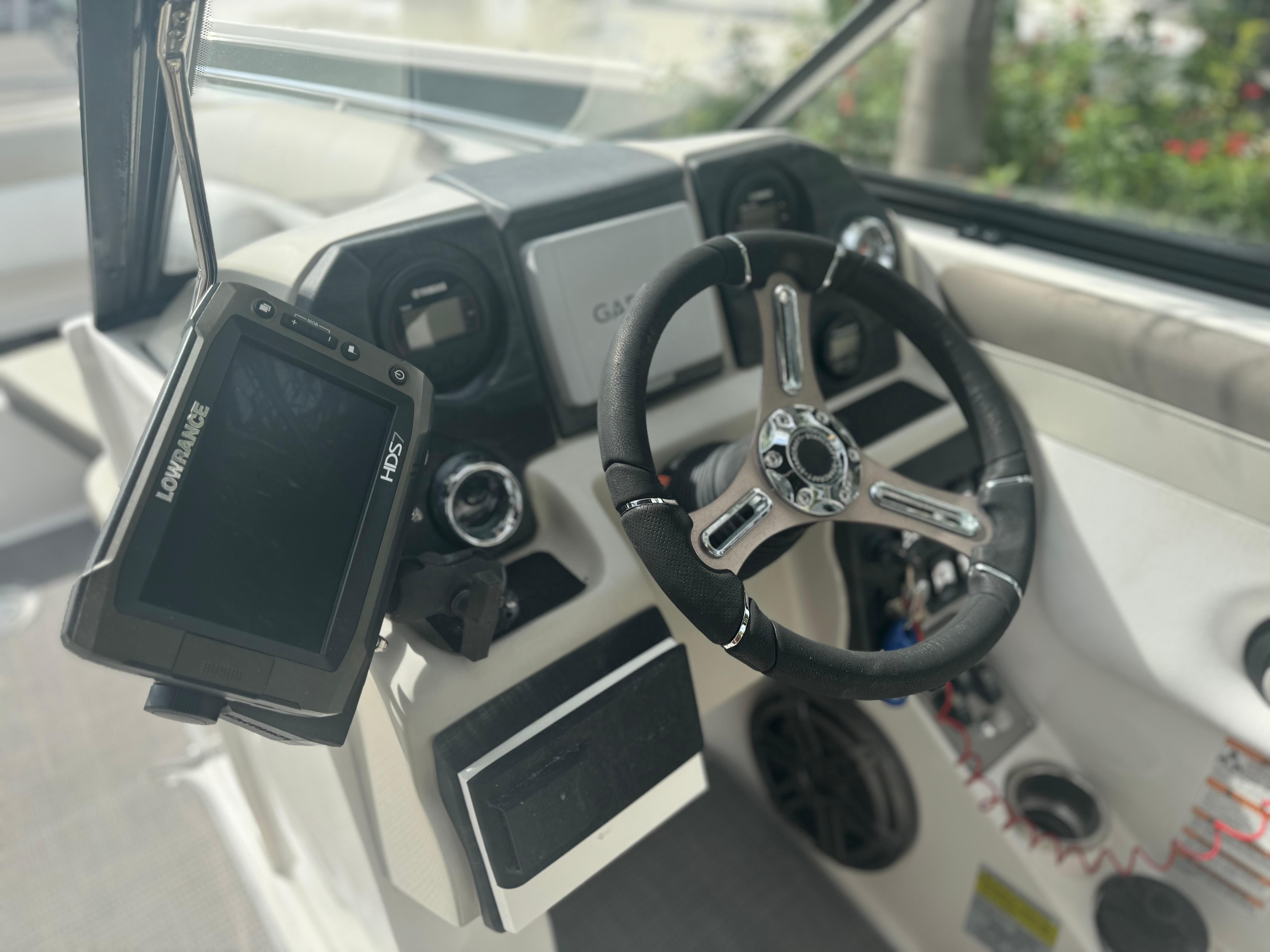 Steering wheel and controls of 2017 Starcraft 230 OB SCX EXT boat with Lowrance HDS7 display.