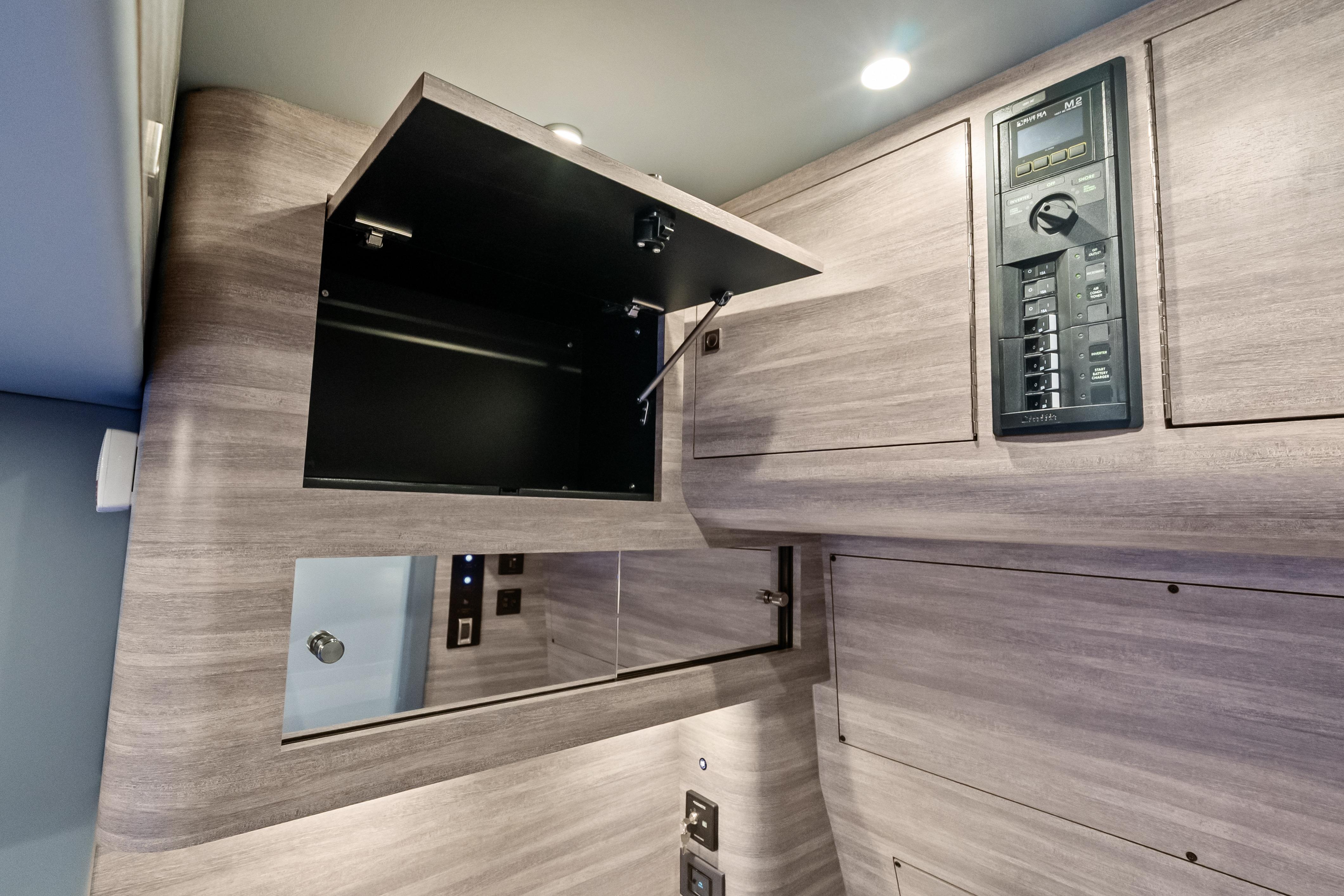 Interior of 2027 Mystic Powerboats M4200, featuring modern cabinetry and control panel.