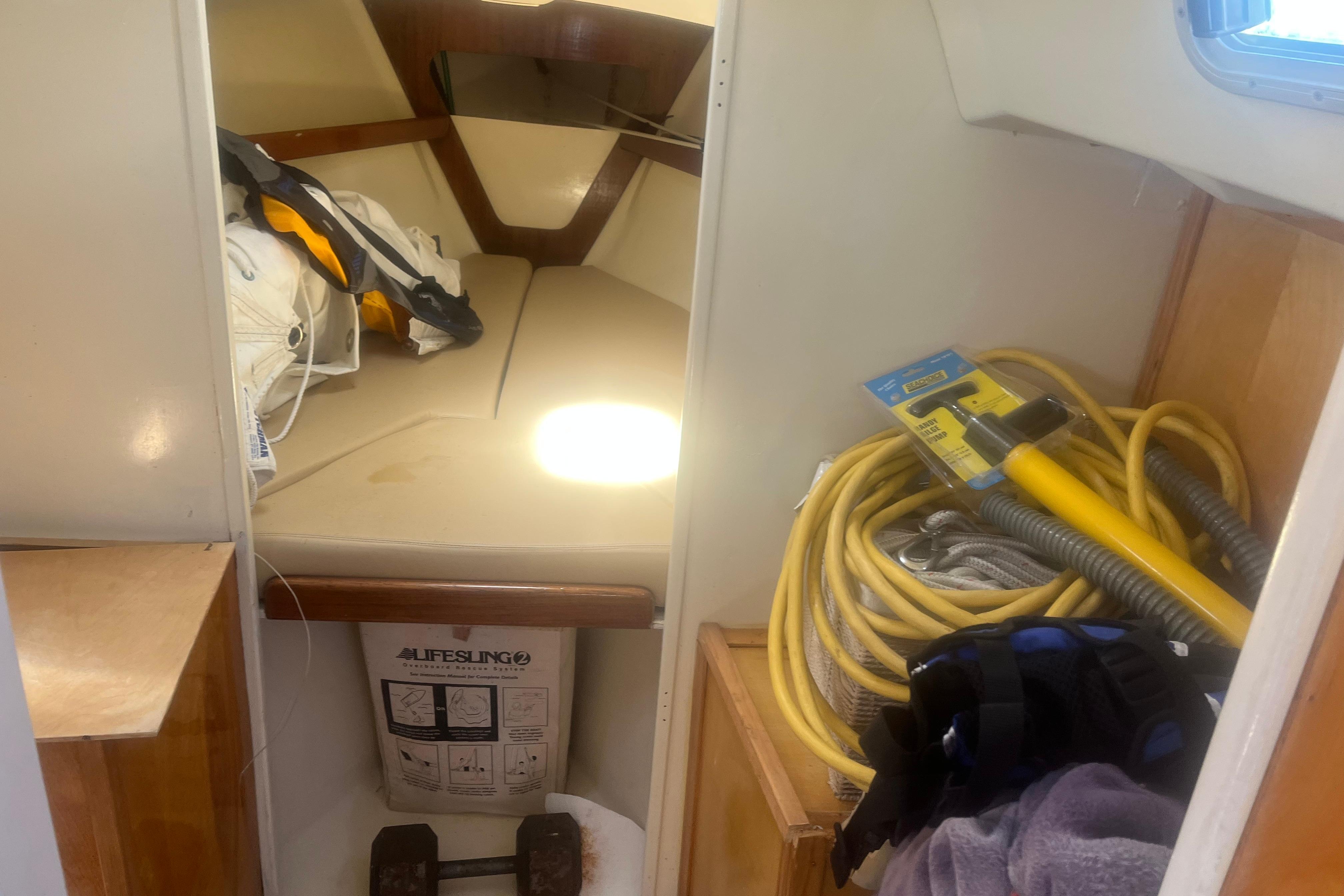 Interior of a 1972 C&C 30 sailboat with ropes and equipment stored.