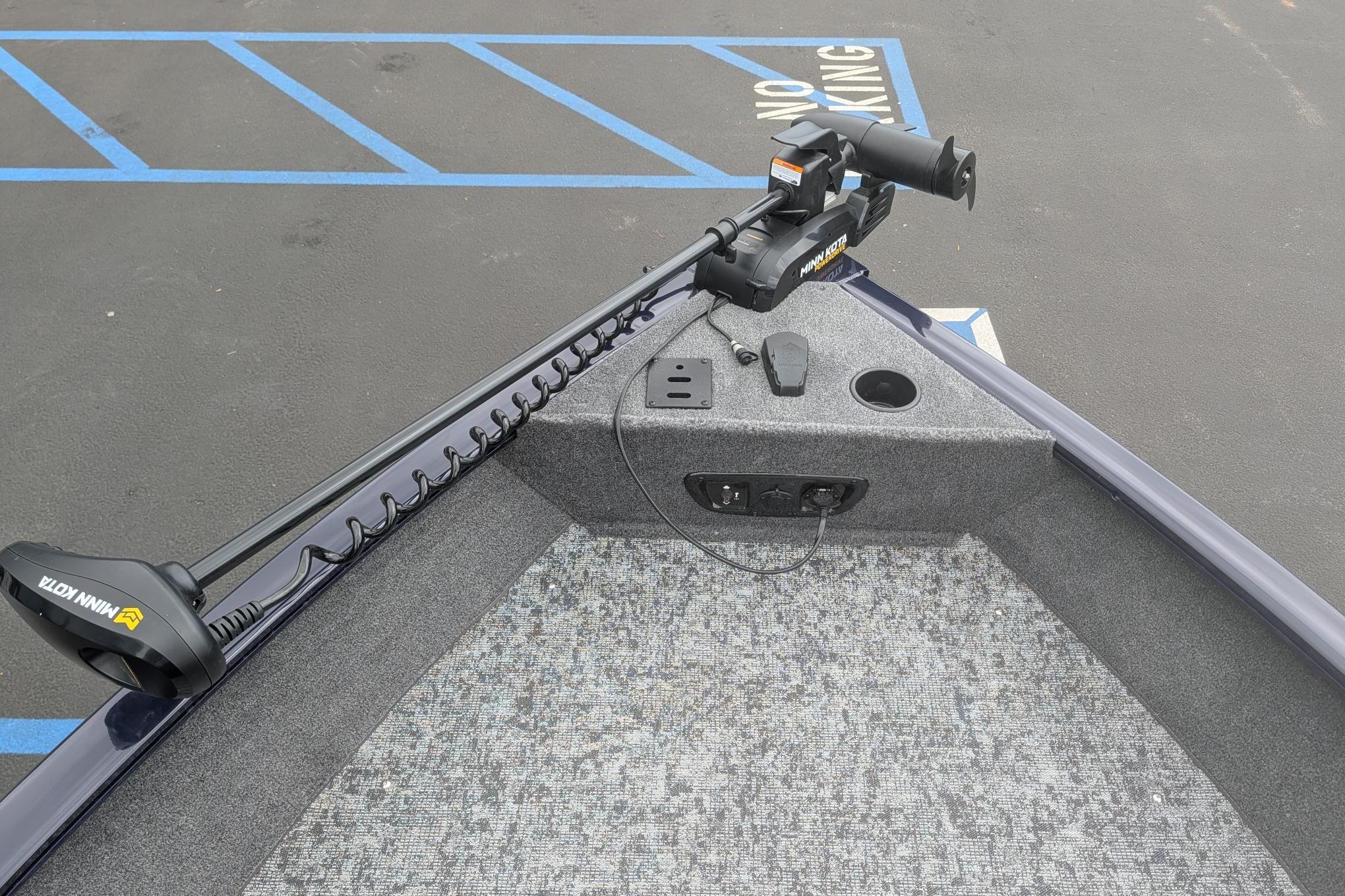 2026 Tracker Pro Guide V-175 WT boat with Minn Kota trolling motor in parking lot.