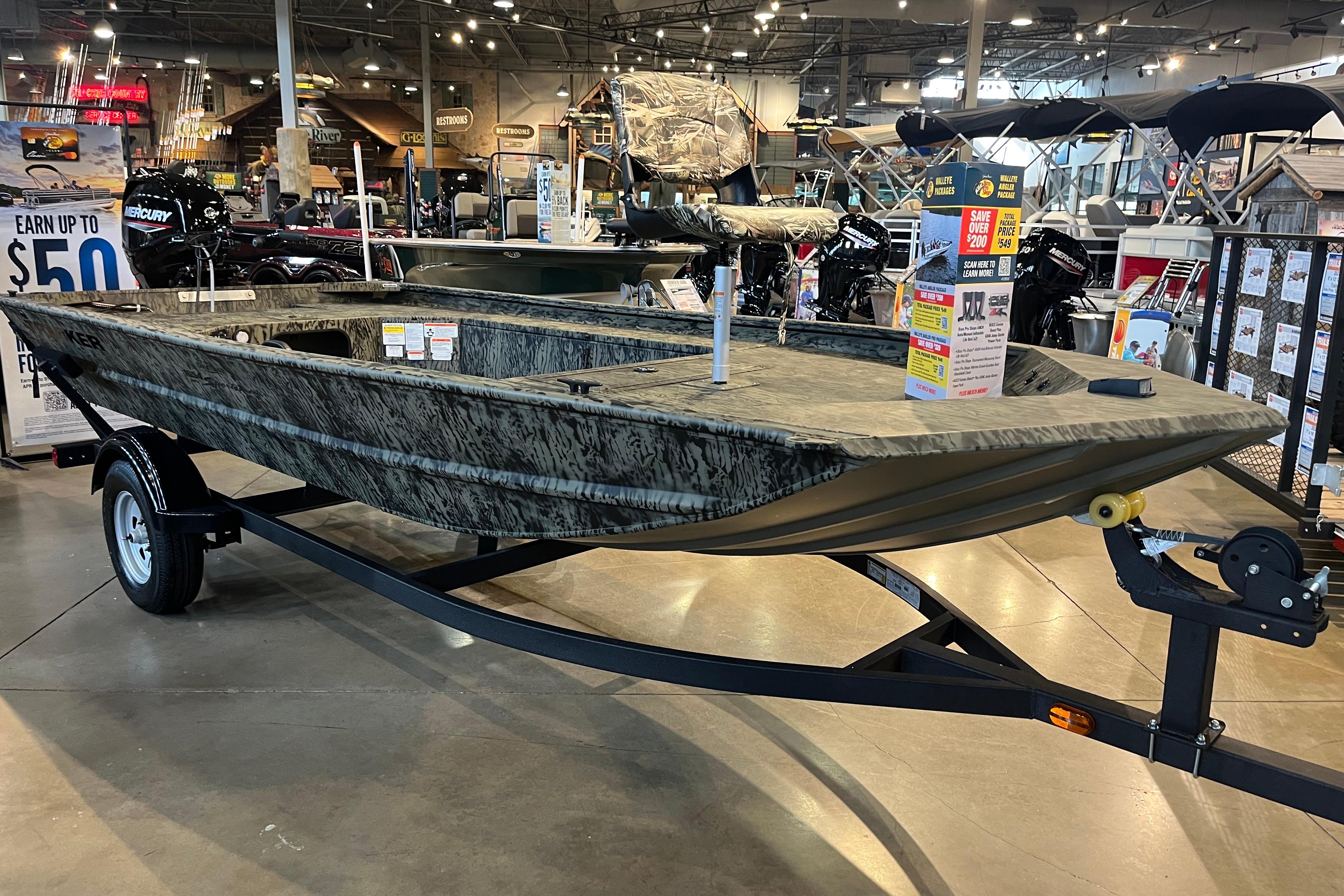 2026 Tracker Grizzly 1654 T Sportsman boat on display in a showroom.