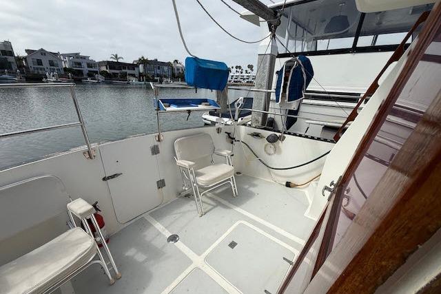 1982 Lancer 45 Motorsailer deck with seating, overlooking marina and waterfront homes.
