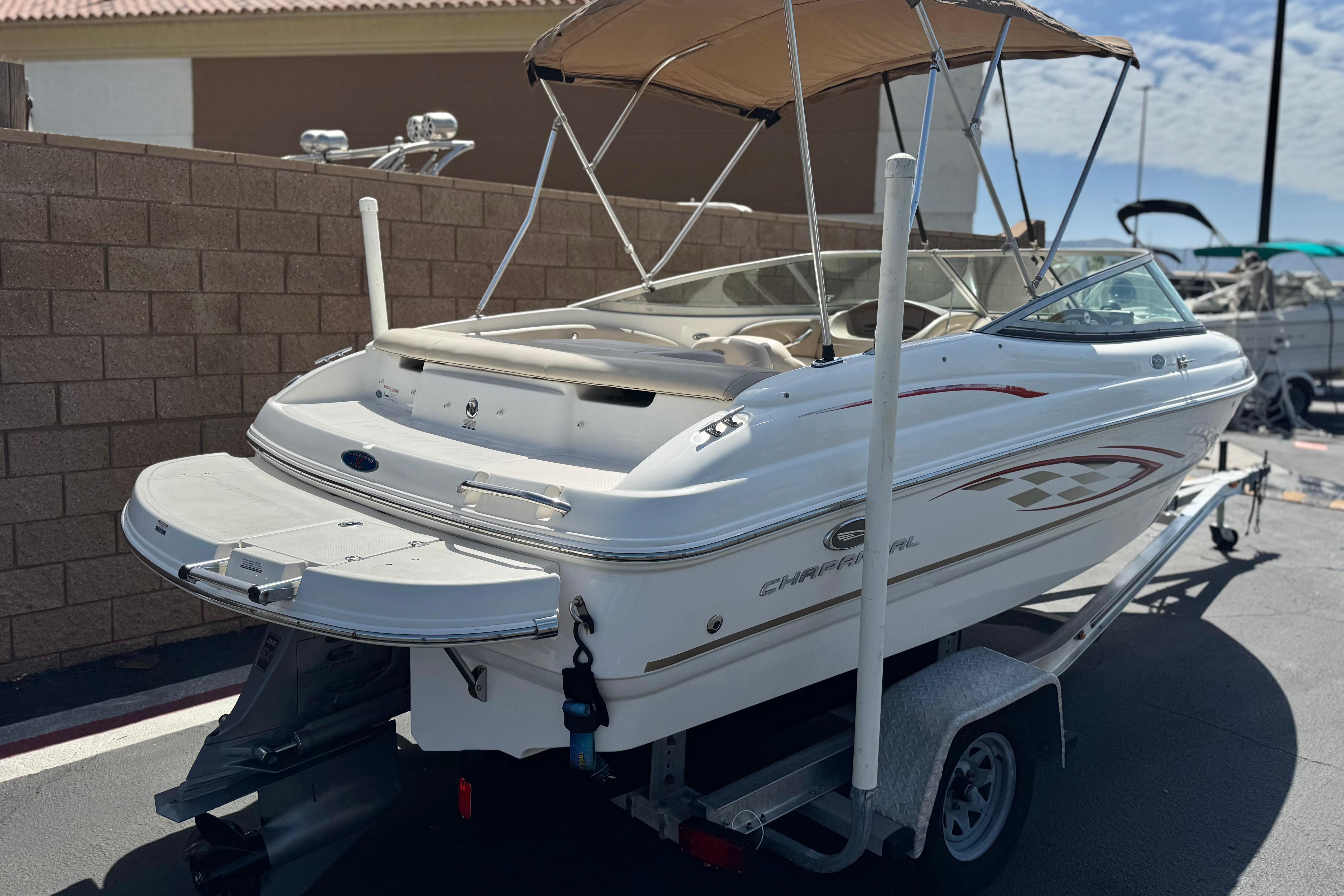 2006 Chaparral 190 SSi boat on trailer, featuring sleek design and swim platform.