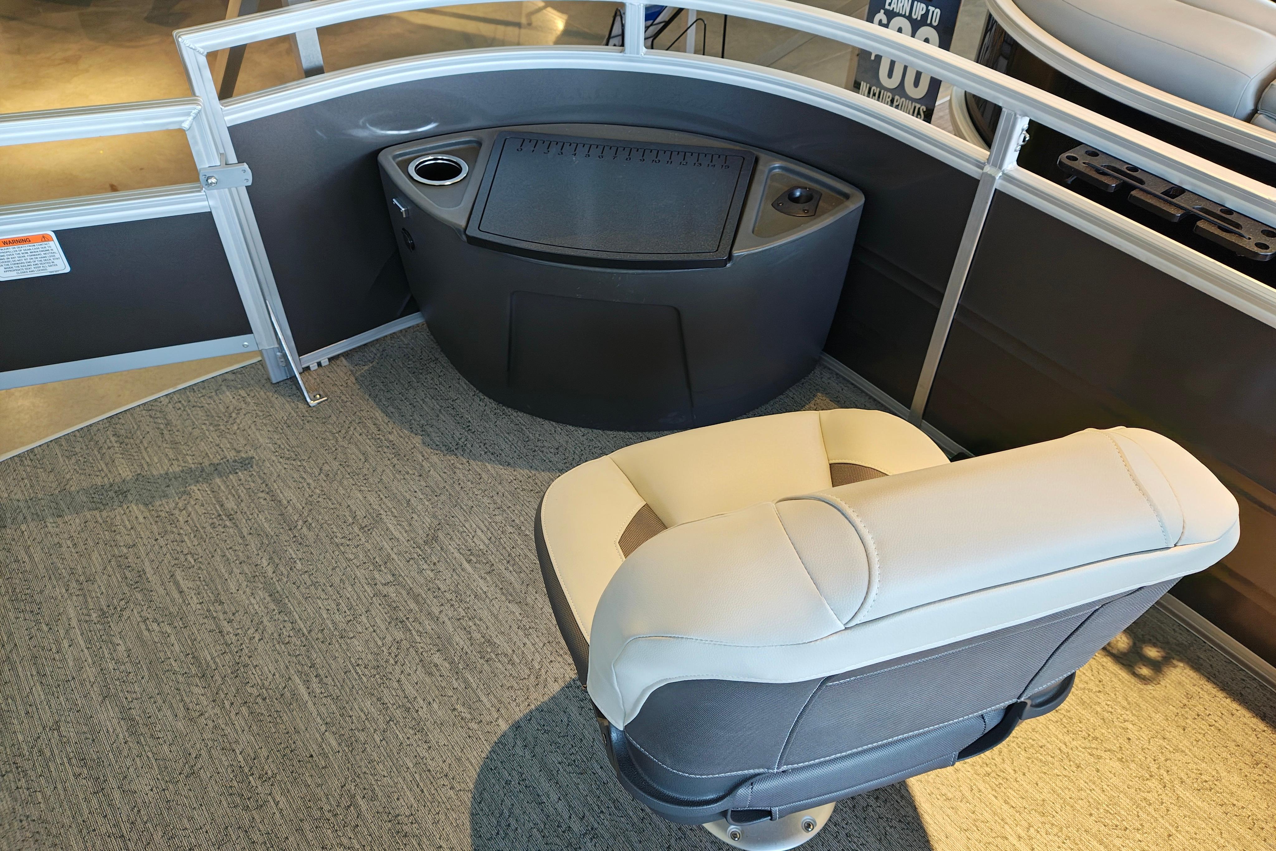 2026 Sun Tracker Fishin' Barge 22 XP3 interior with seating and storage area.