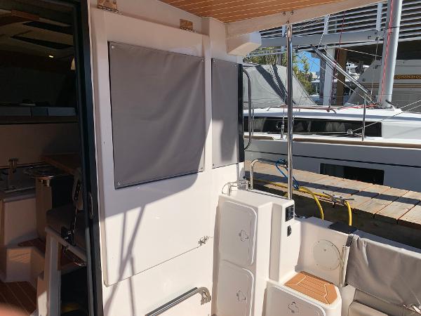 2021 Cutwater C-32 CB boat interior with seating and storage, docked at marina.
