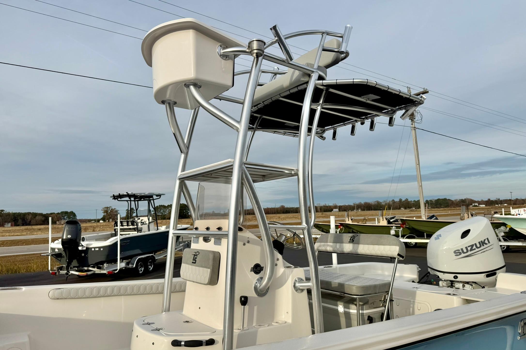 2025 Carolina Skiff 21 LS boat with Suzuki outboard motor and T-top structure.