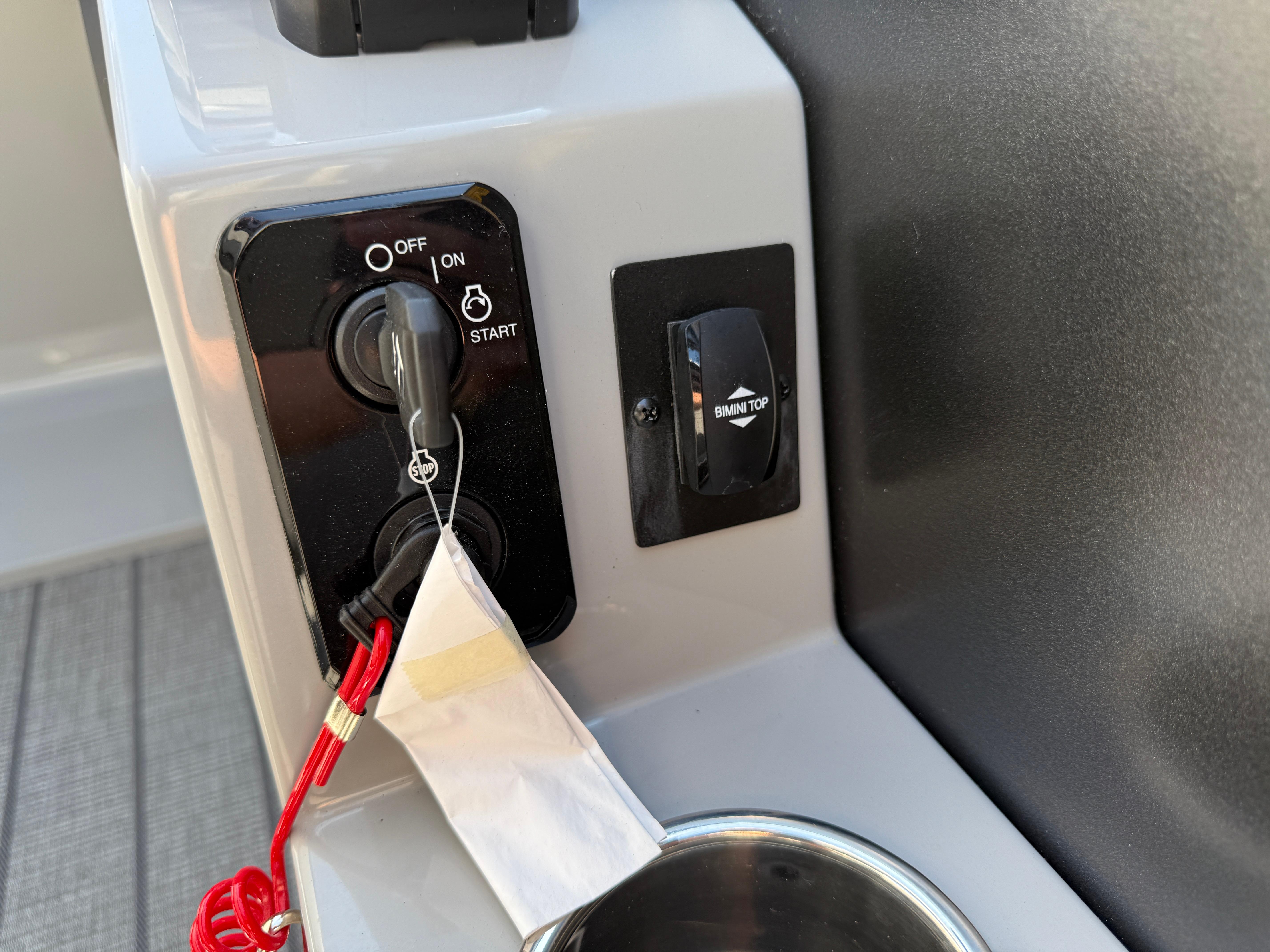 Control panel of 2026 Bentley Pontoons Legacy 223 Navigator with ignition and Bimini top switch.