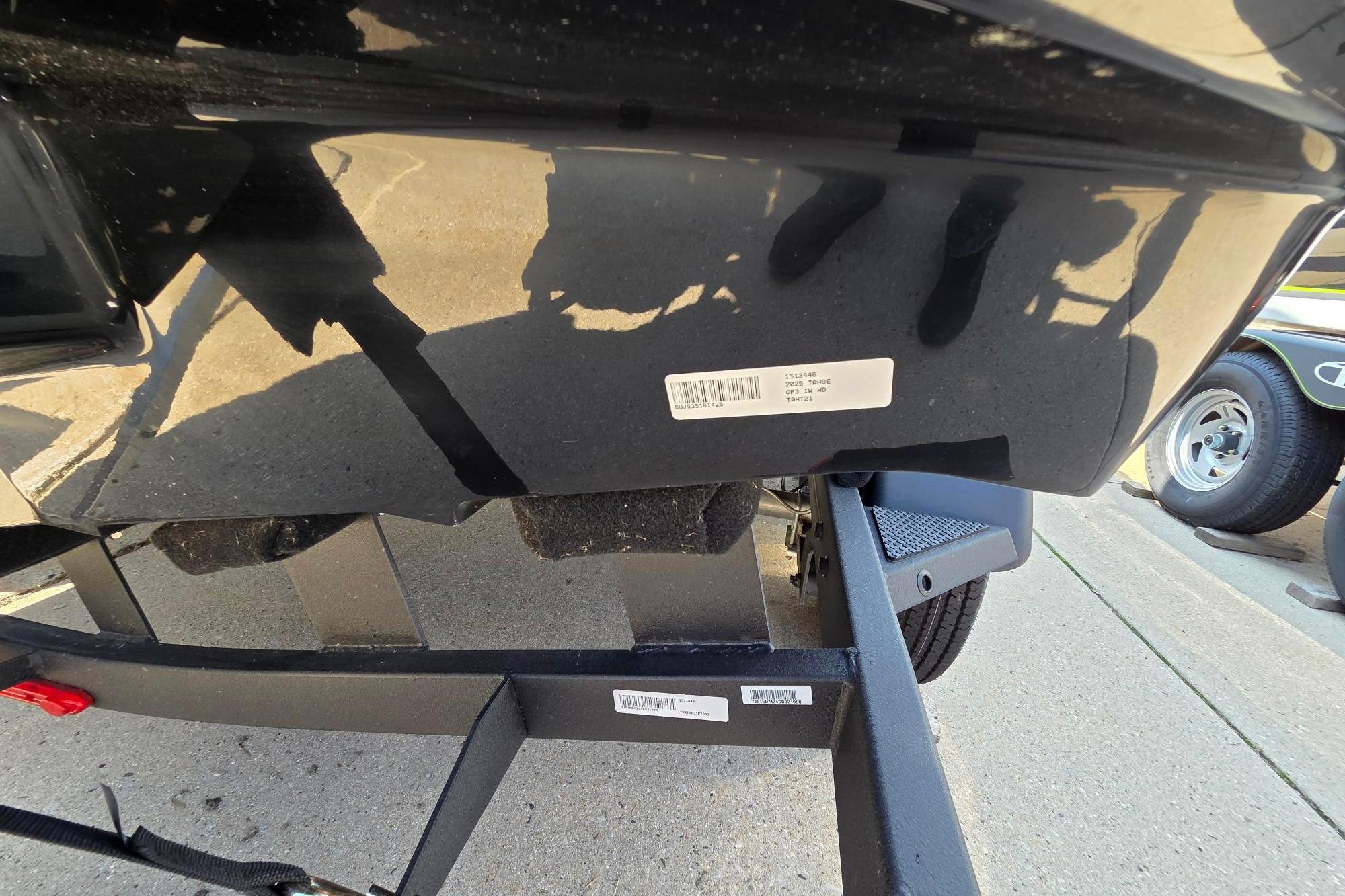 2025 Tahoe T21 boat on trailer, close-up of hull with barcode sticker.