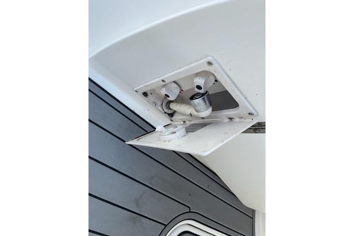 Bayliner 285 Cruiser 2012 boat detail showing a utility compartment with plumbing fixtures.