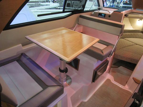 2025 Cutwater C-248 Coupe interior with seating and wooden table.