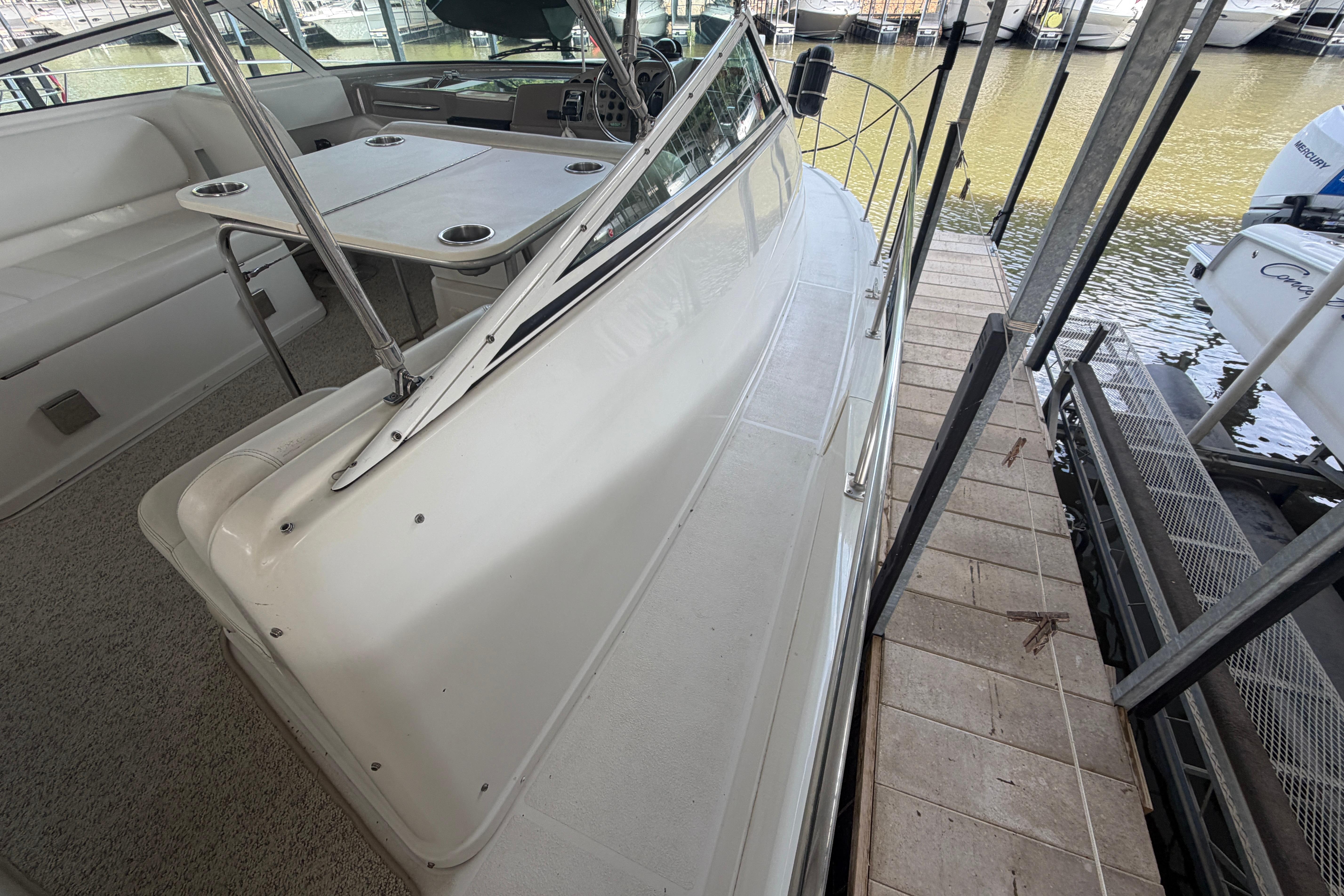 2000 Carver 350 Mariner yacht interior with seating and table, docked by the water.