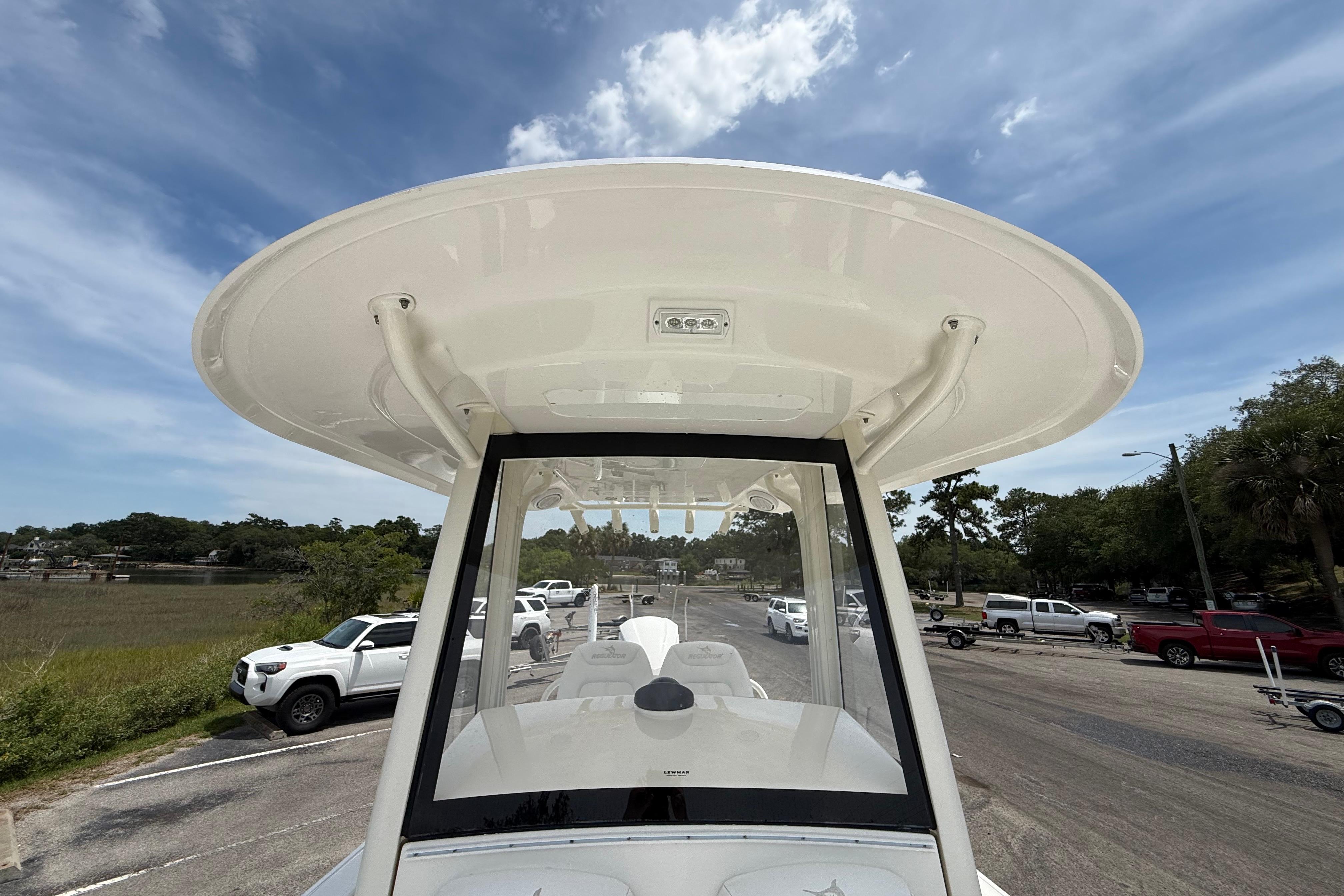2019 Regulator 26XO boat with T-top, parked in a scenic outdoor setting.