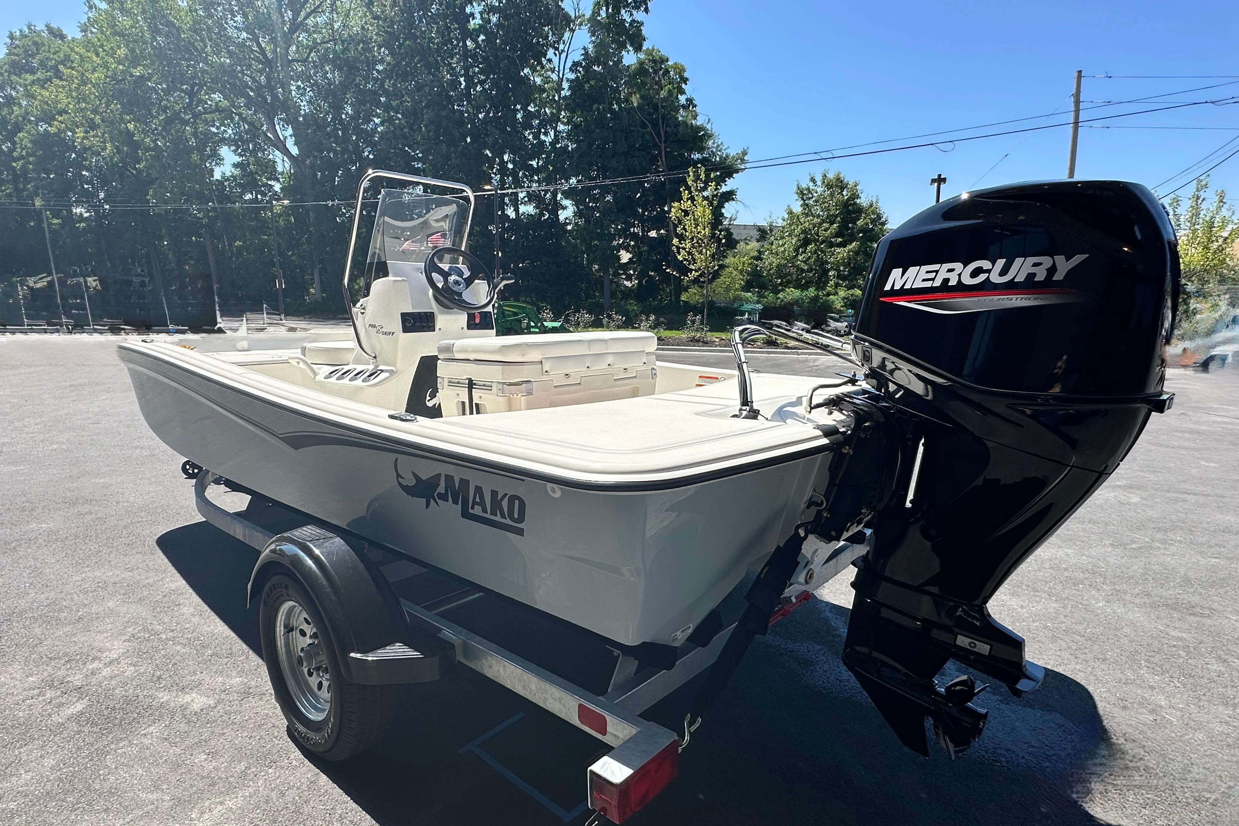 2026 Mako Pro Skiff 15 CC boat with Mercury outboard motor on trailer.