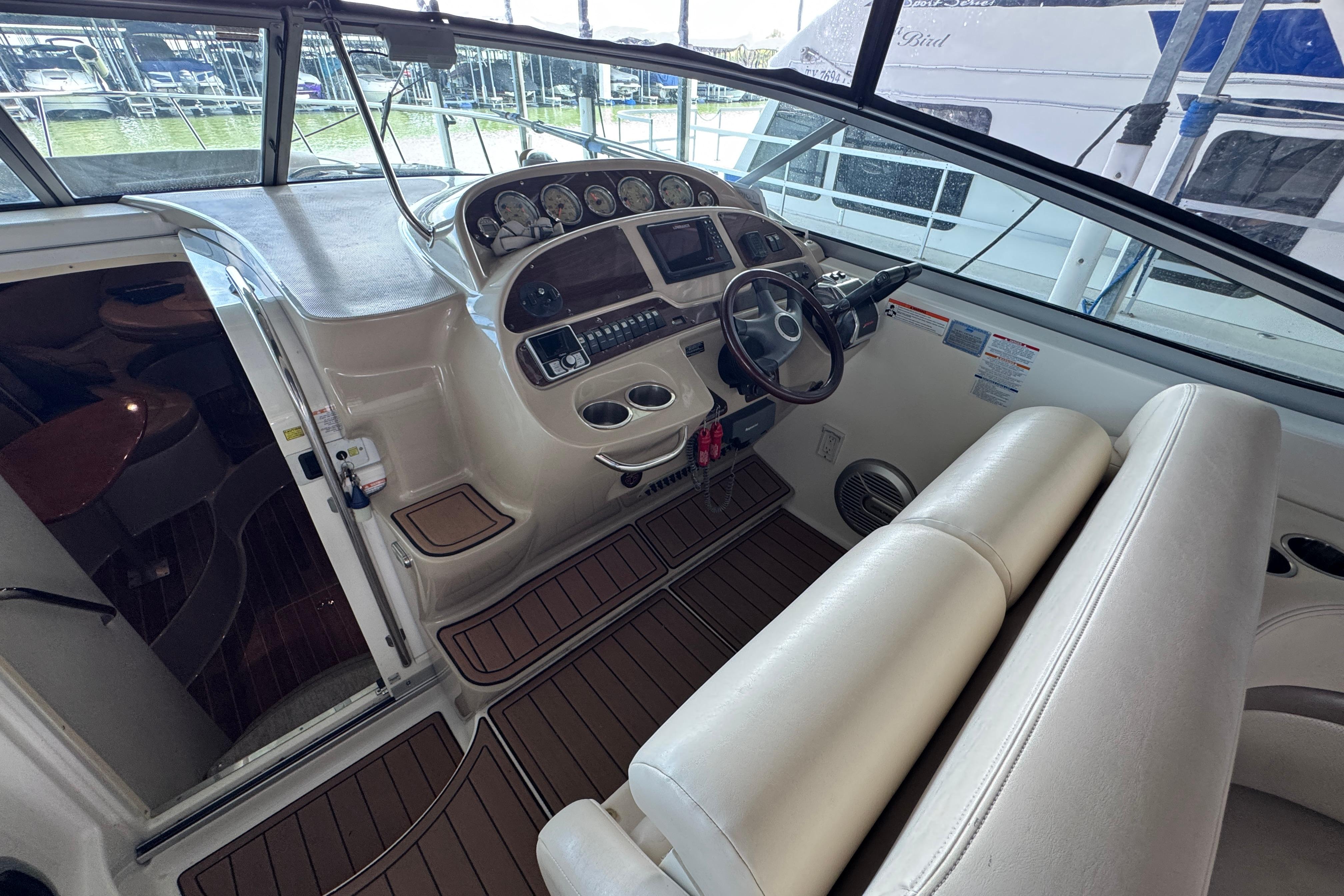 2006 Chaparral 330 Signature boat interior with helm, steering wheel, and seating.