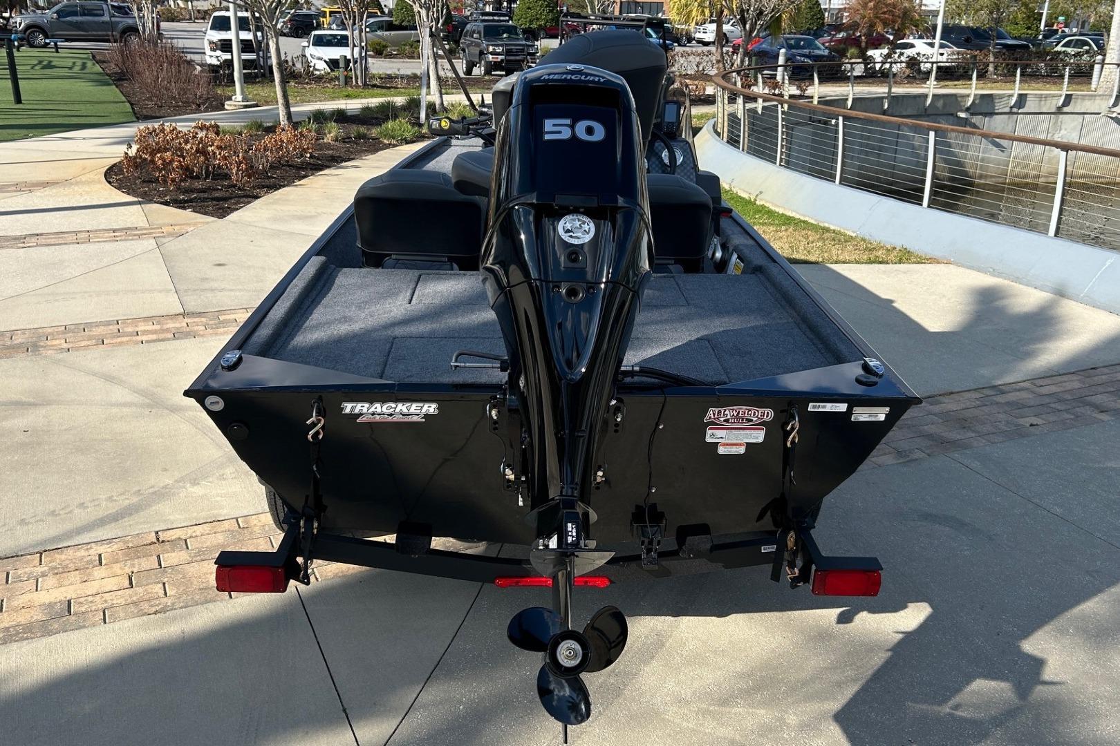 2026 Tracker Bass Tracker Classic XL boat with 50 HP engine, parked outdoors.