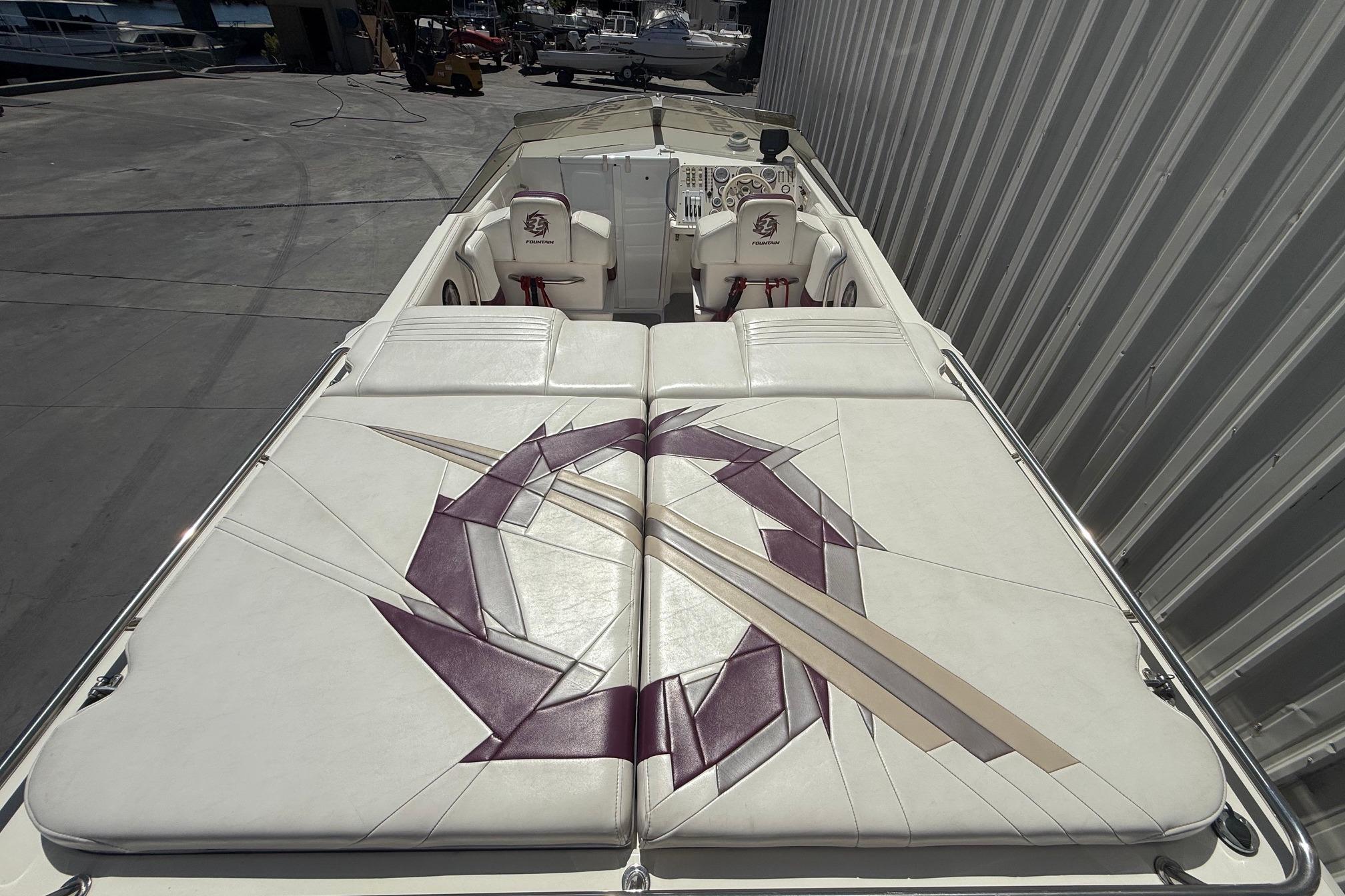 1998 Fountain 35 Lightning boat with custom white and purple upholstery design.
