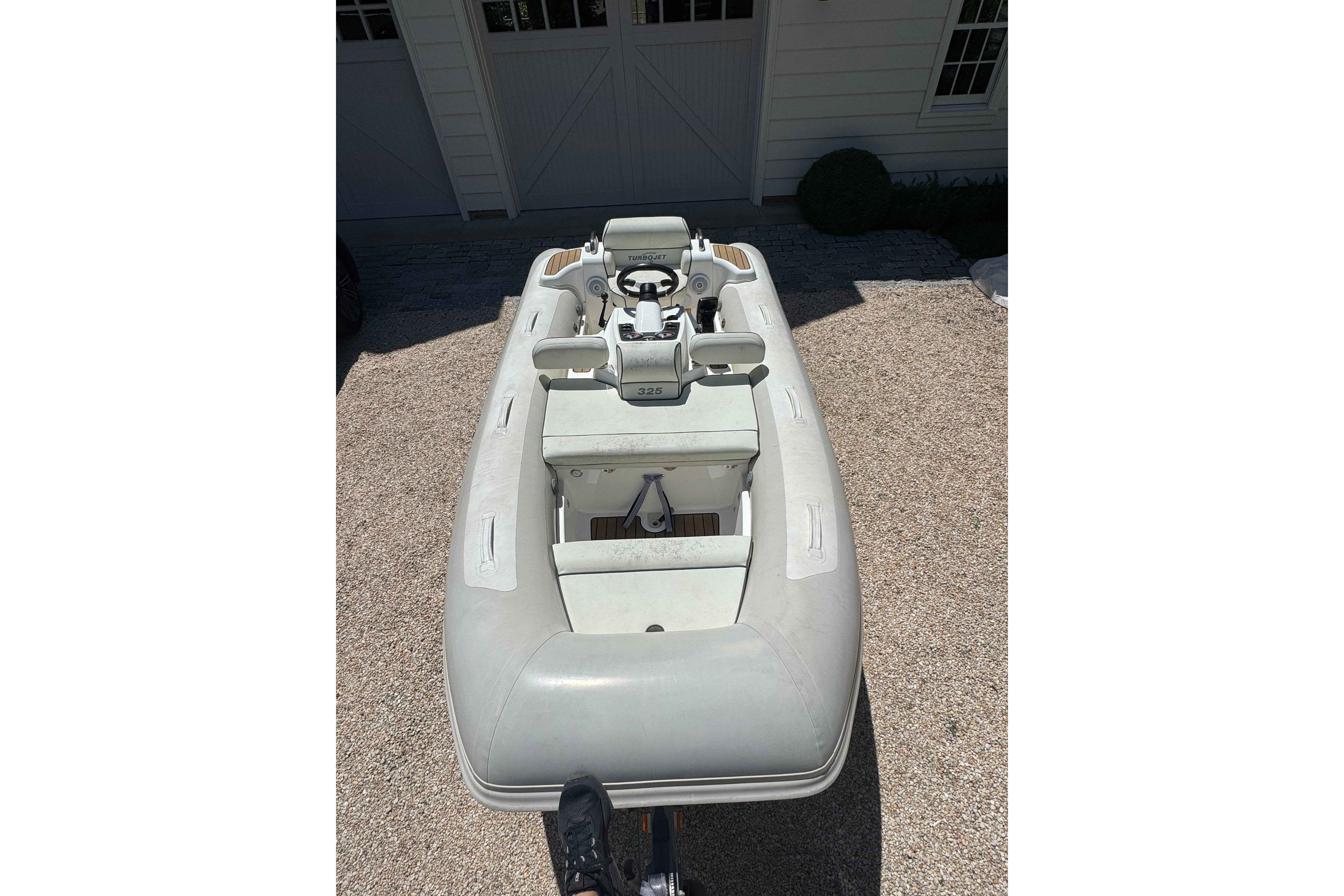 2017 Williams Jet Tenders Turbojet 325 inflatable boat on gravel driveway.