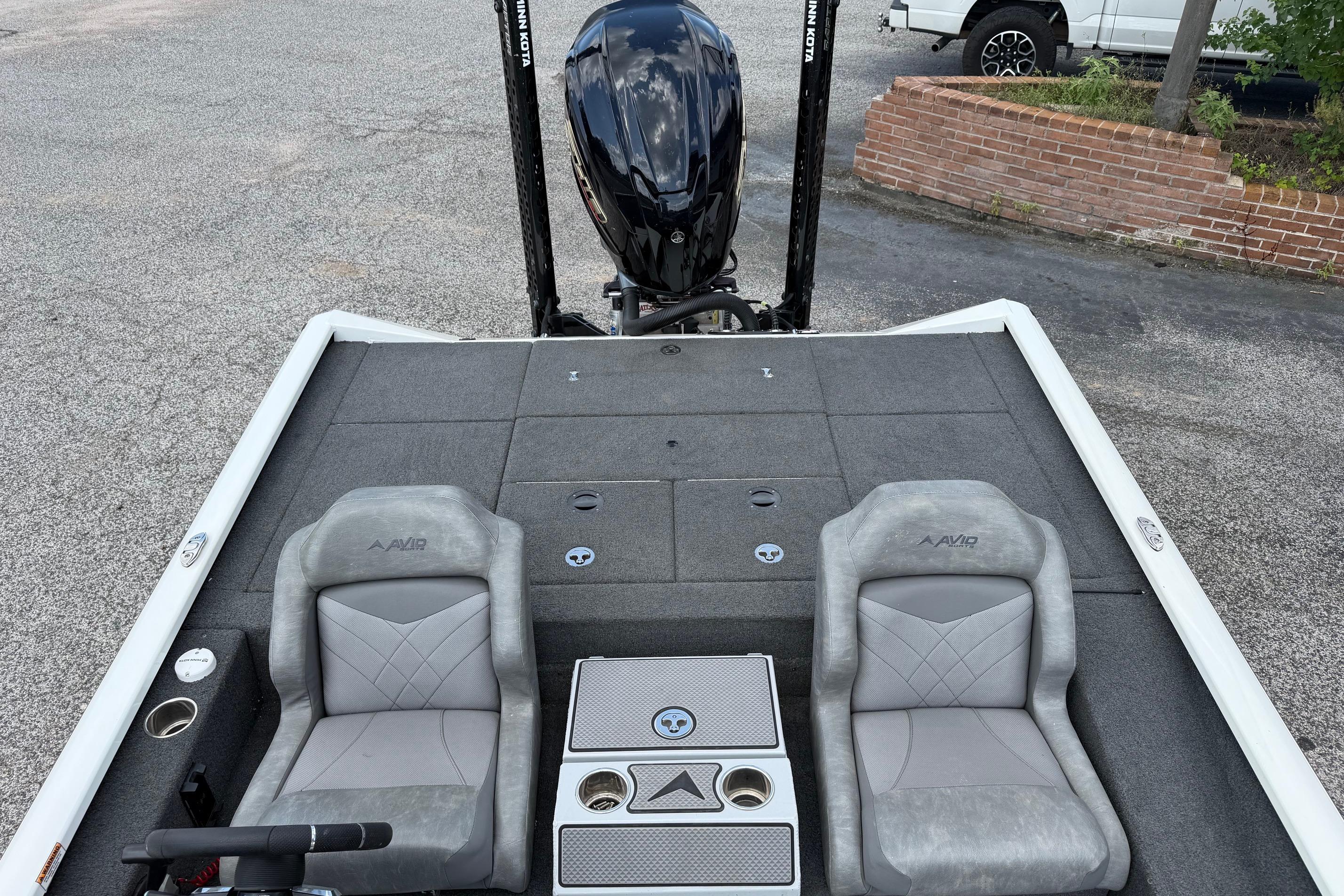 2024 Avid 21 XB Elite boat interior with dual gray seats and motor view.