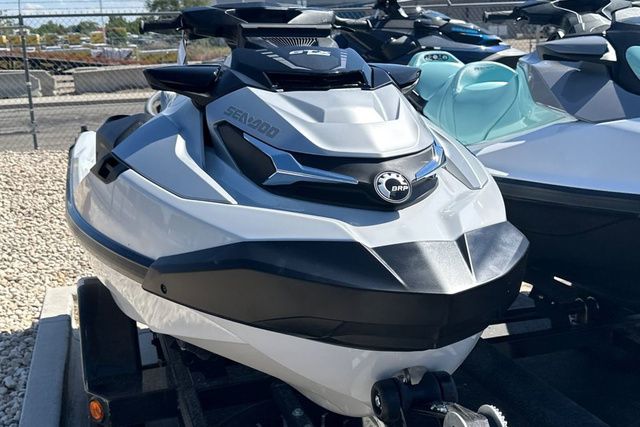 A modern Sea-Doo jet ski sits on a trailer in an outdoor area.