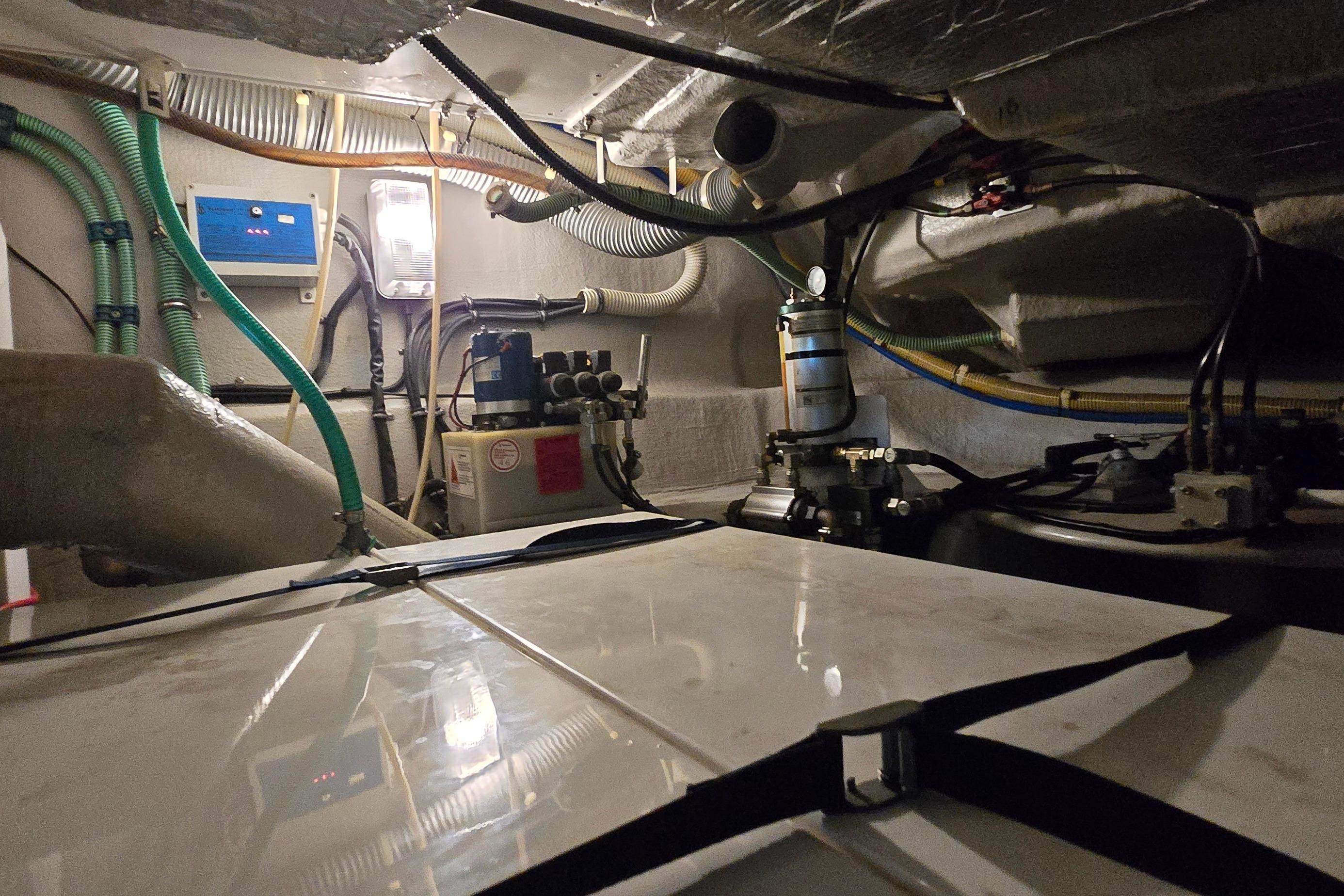 Engine room of a 2004 Sunseeker Camargue 50 yacht, showcasing mechanical components and wiring.