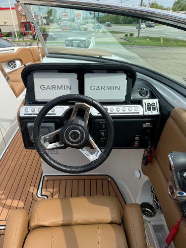 2025 Crownline 290 SS boat dashboard with dual Garmin displays and leather seating.