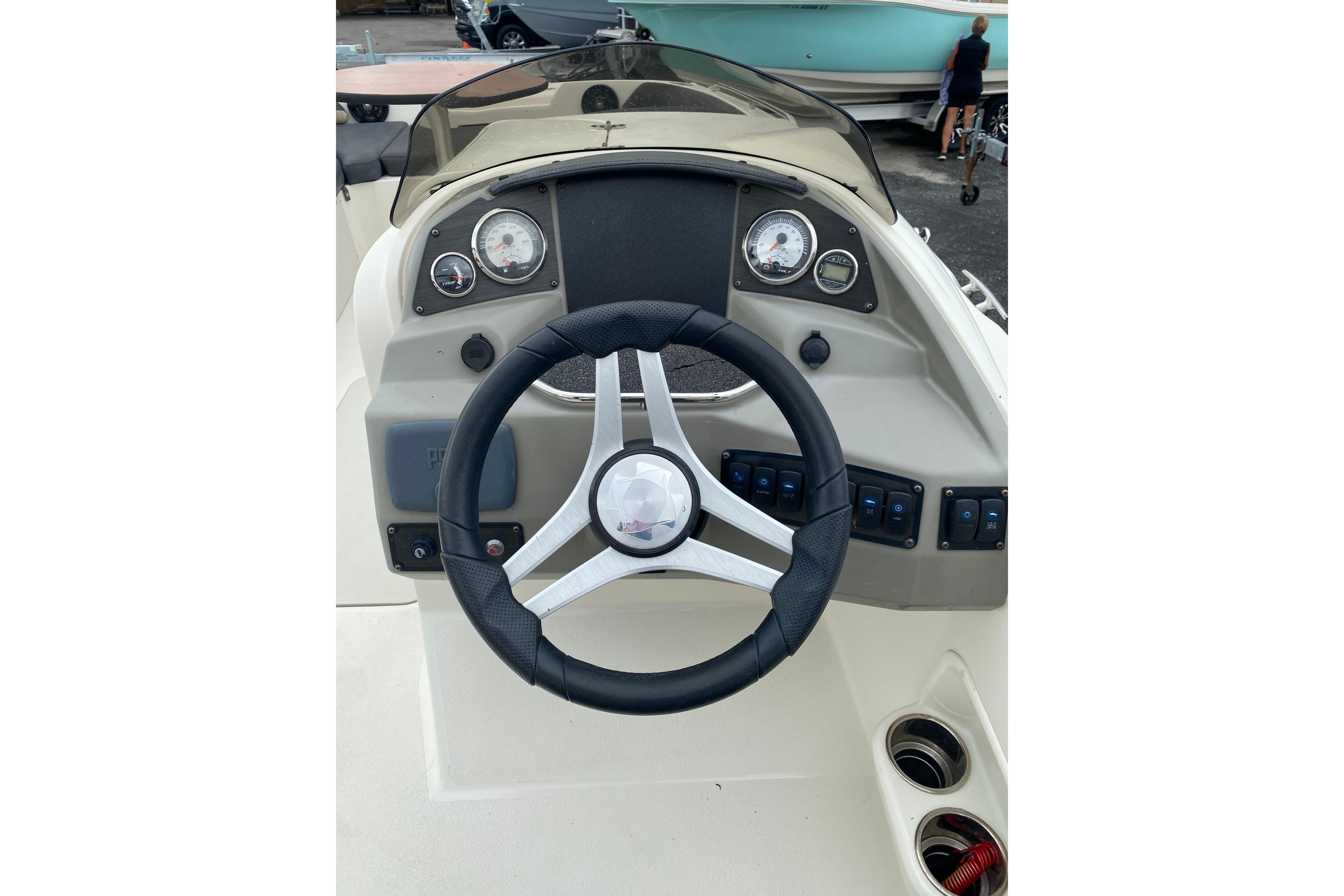Steering console of a 2018 Stingray 212 SC boat with gauges and controls.