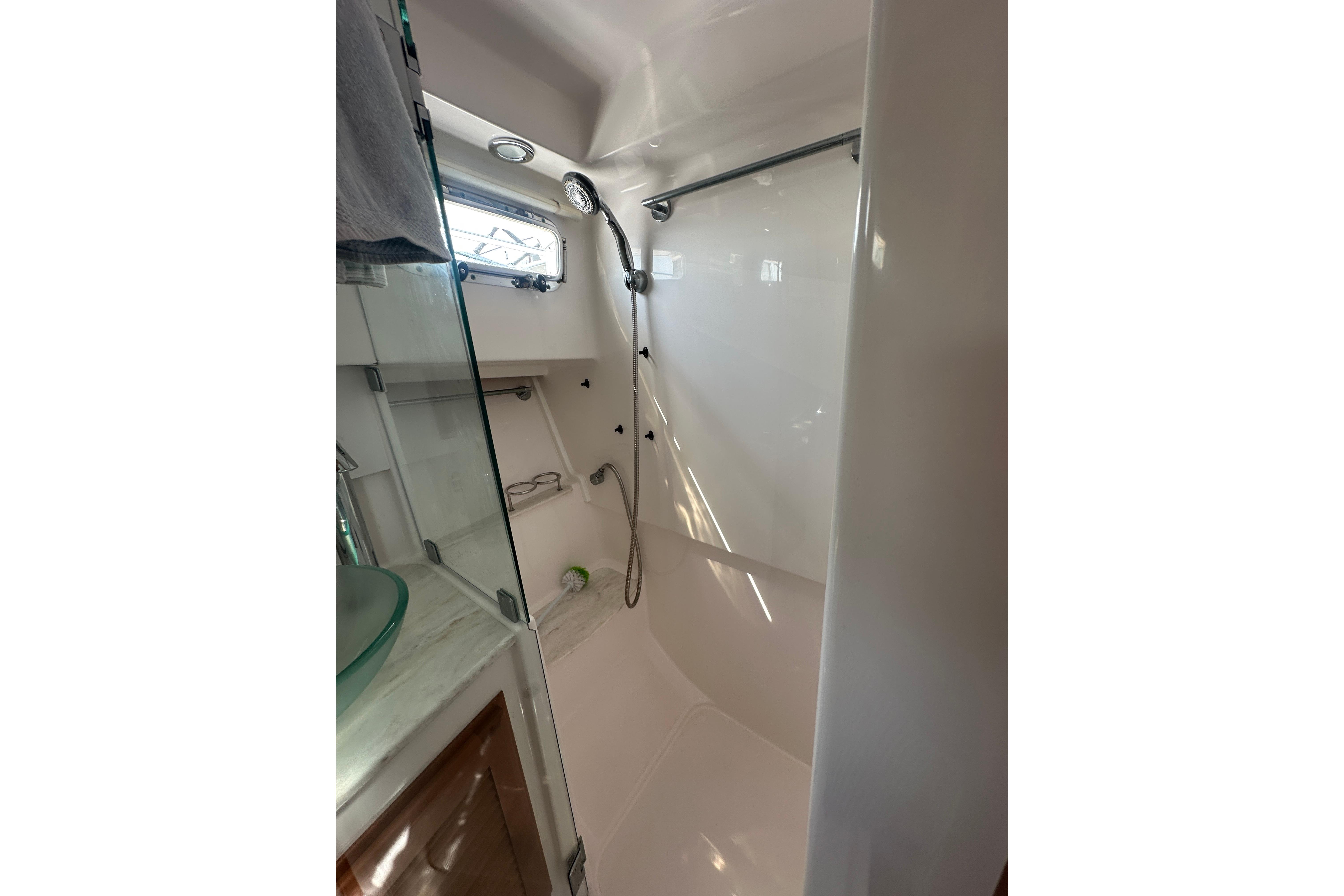 Bathroom interior of 2013 Sabre 38 Salon Express yacht, featuring shower and window.