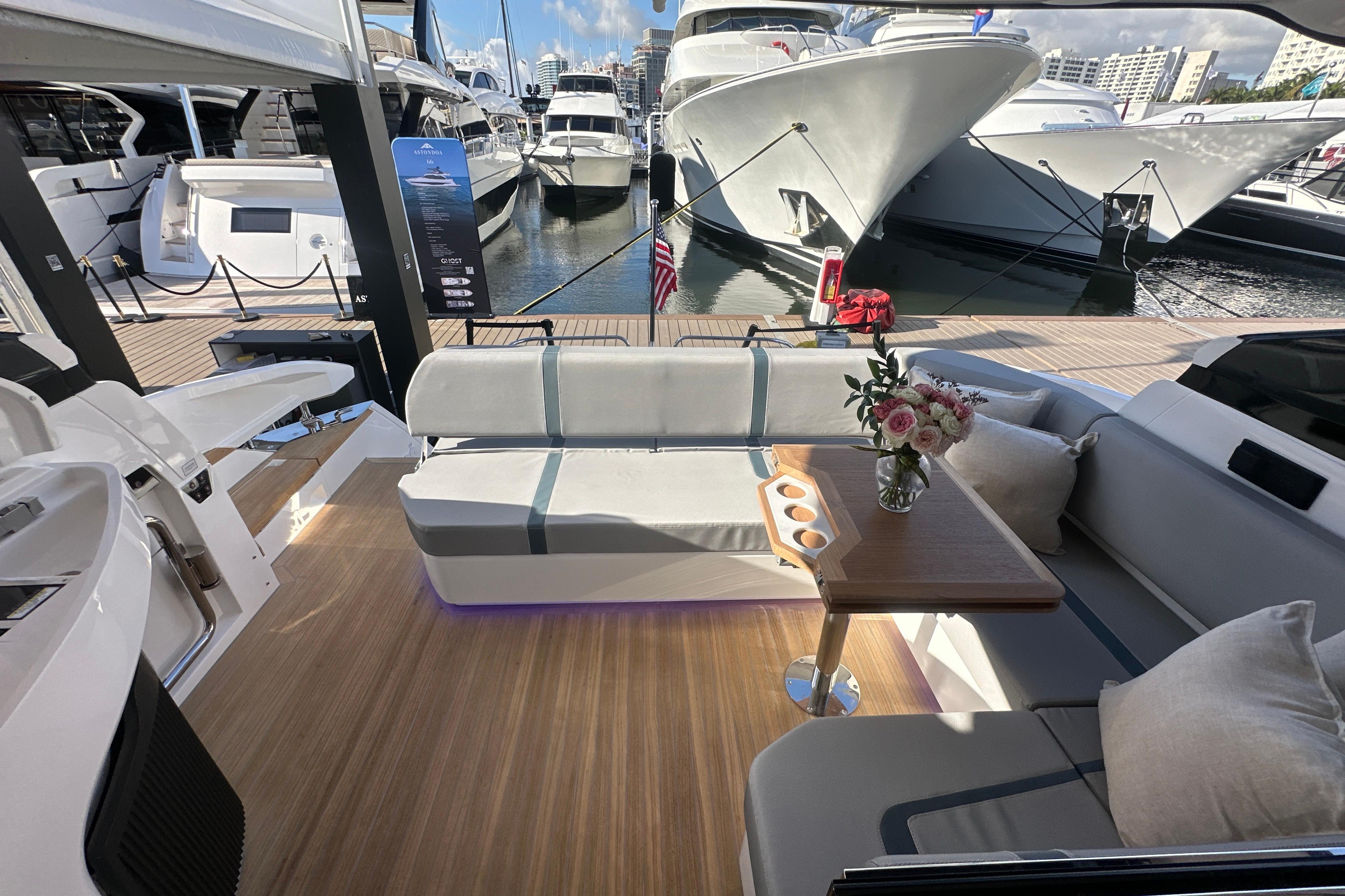 Luxurious Fairline Targa 47 GT yacht interior, featuring elegant seating and a wooden table with flowers.