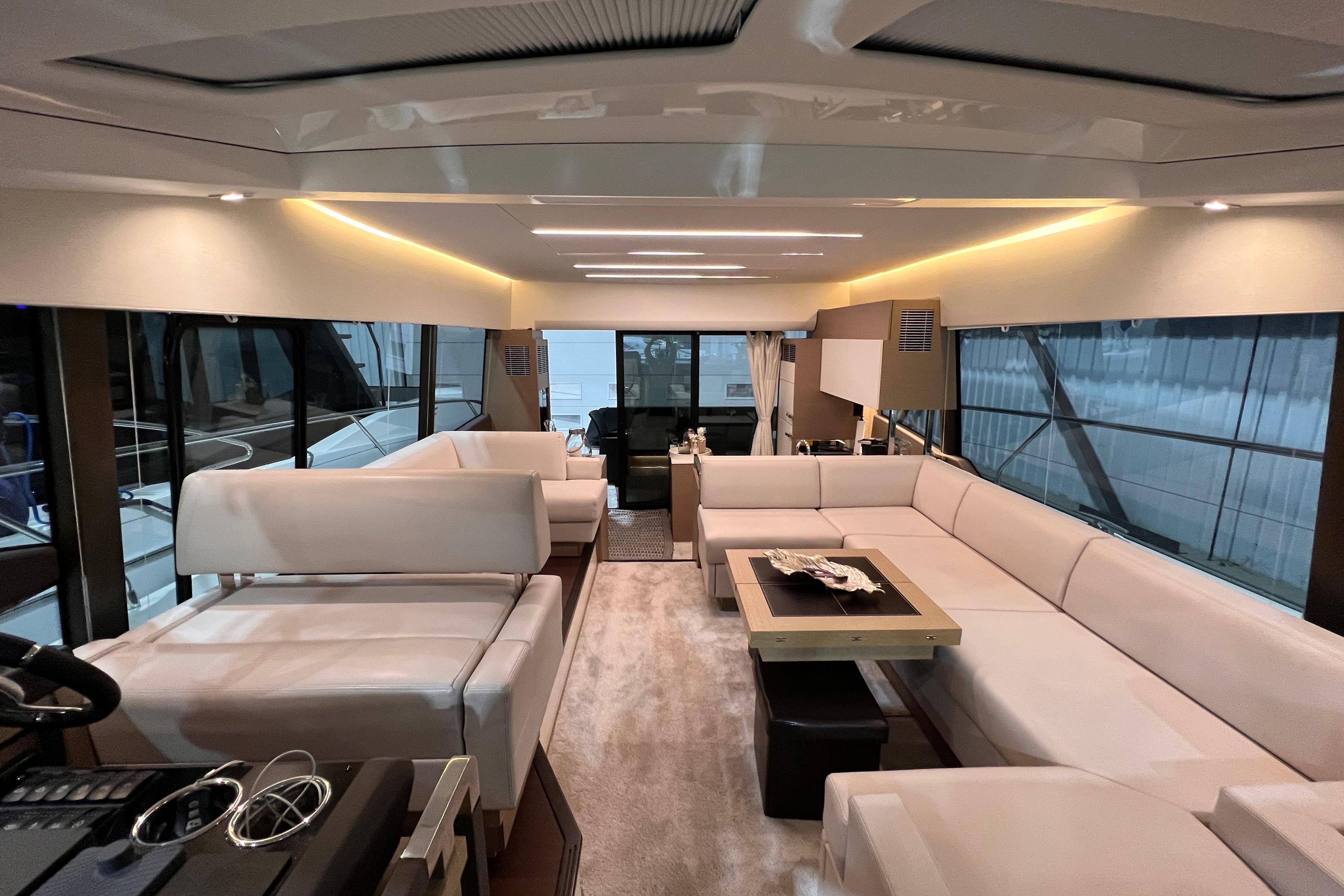 Luxurious interior of a 2018 Prestige 520 yacht with elegant white seating and modern design.