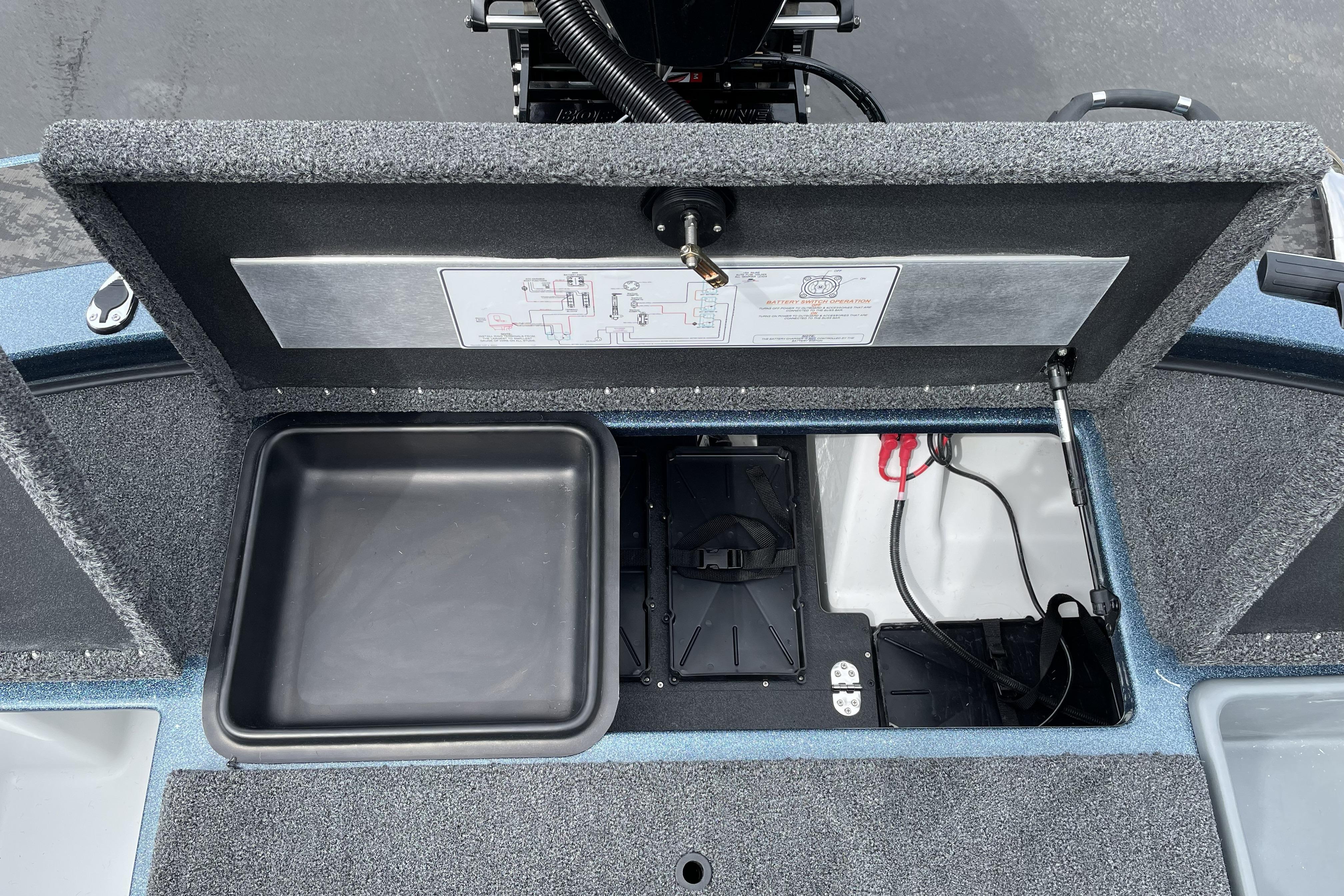 Open storage compartment of 2026 Nitro Z21 XL boat, showcasing interior layout and wiring.