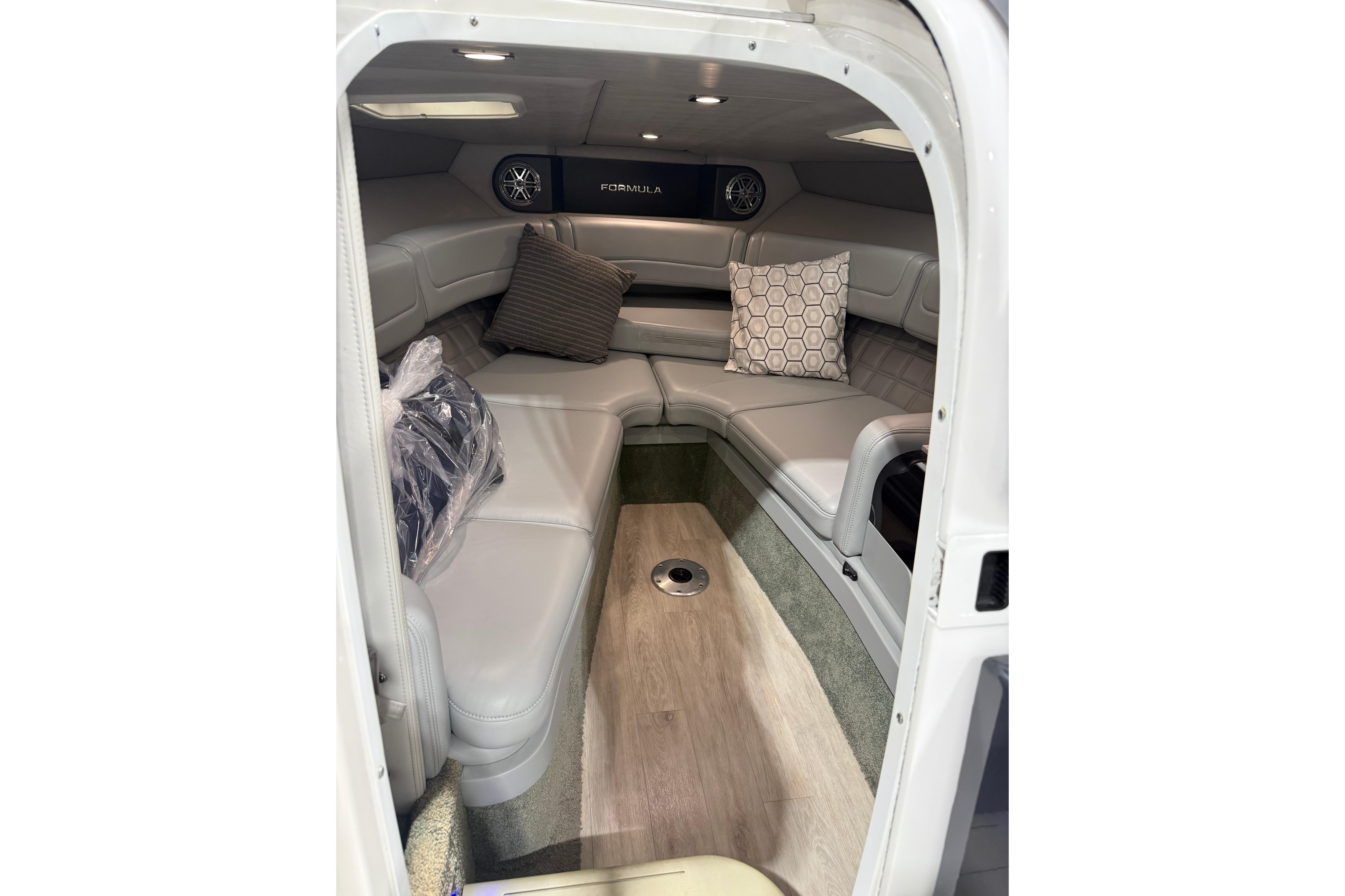 Interior of 2018 Formula 270 Sun Sport boat with cushioned seating and decorative pillows.