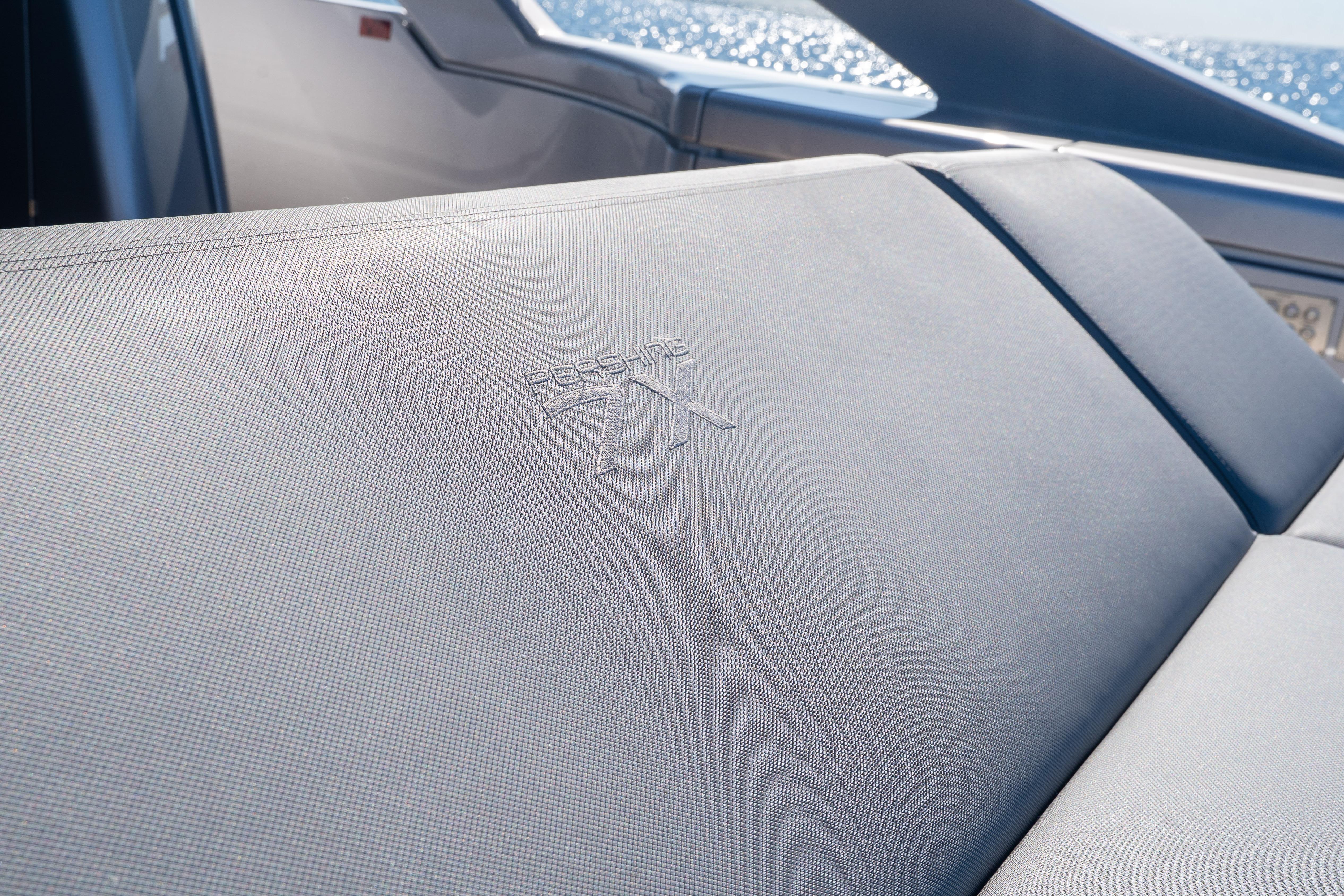 2024 Pershing 7X yacht interior with embossed logo on sleek seating.