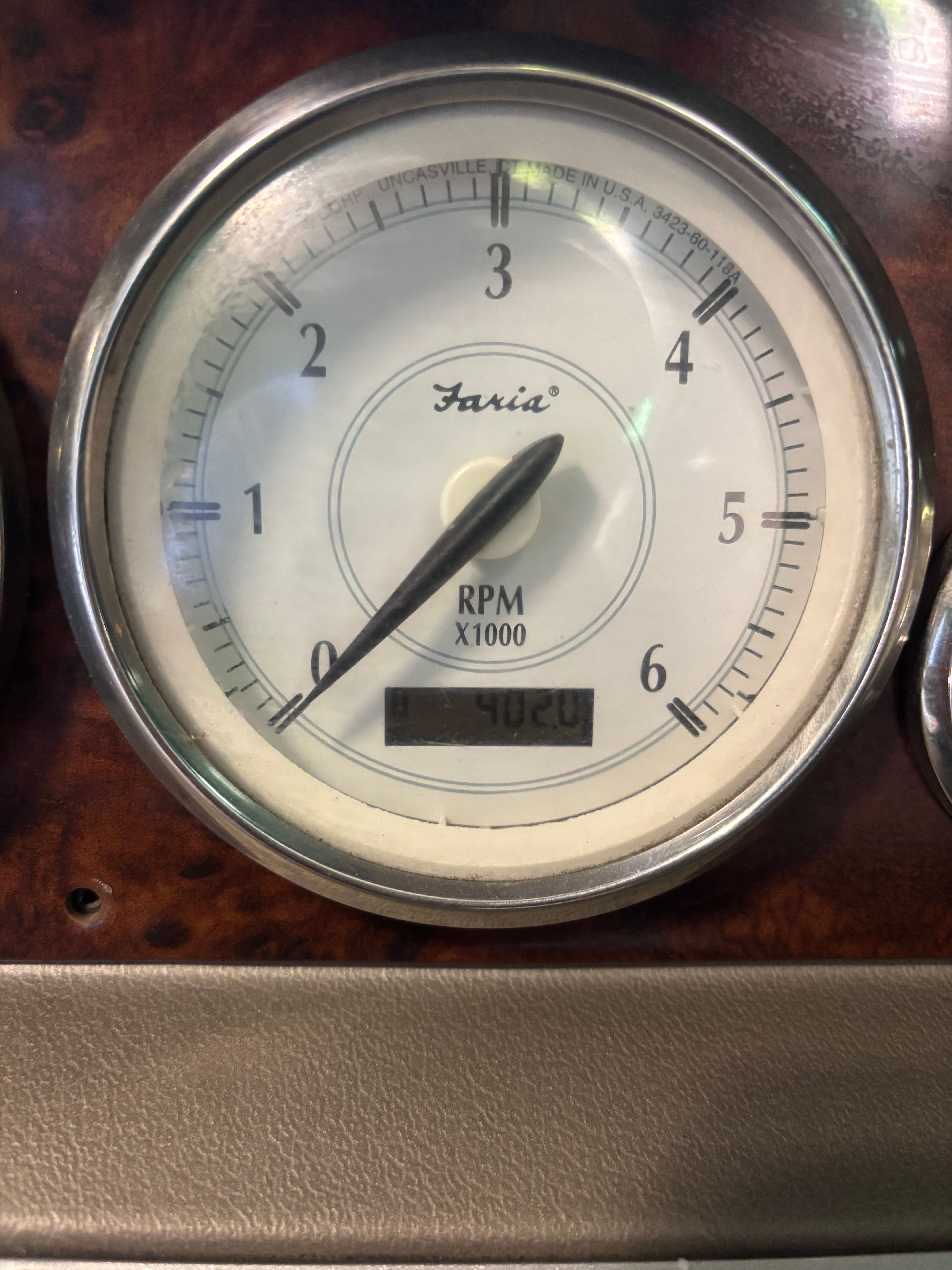 Close-up of a tachometer with a scale from 0 to 6. It reads about 3.5.