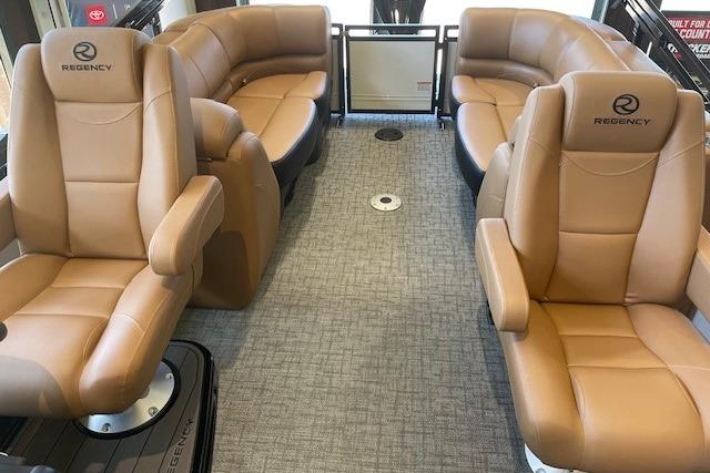 Luxurious interior of 2026 Regency 230 DL boat with tan leather seating and modern design.