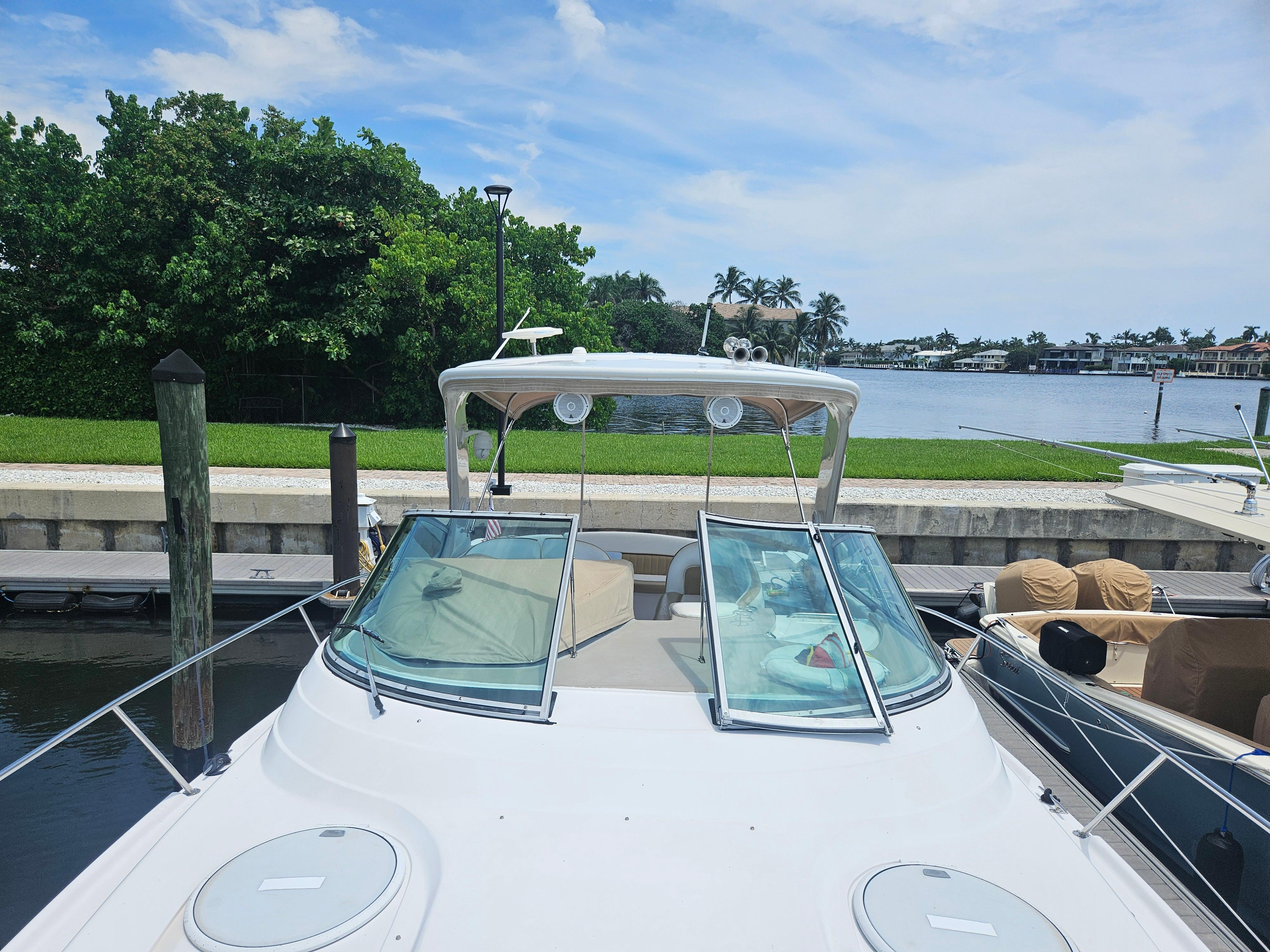 2005 Four Winns 378 Vista boat docked by a scenic waterfront.