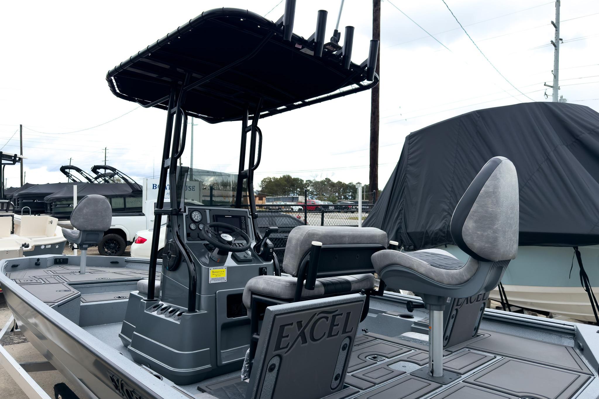 2026 Excel Bay Pro Elite 230 boat with T-top and dual seating, displayed outdoors.