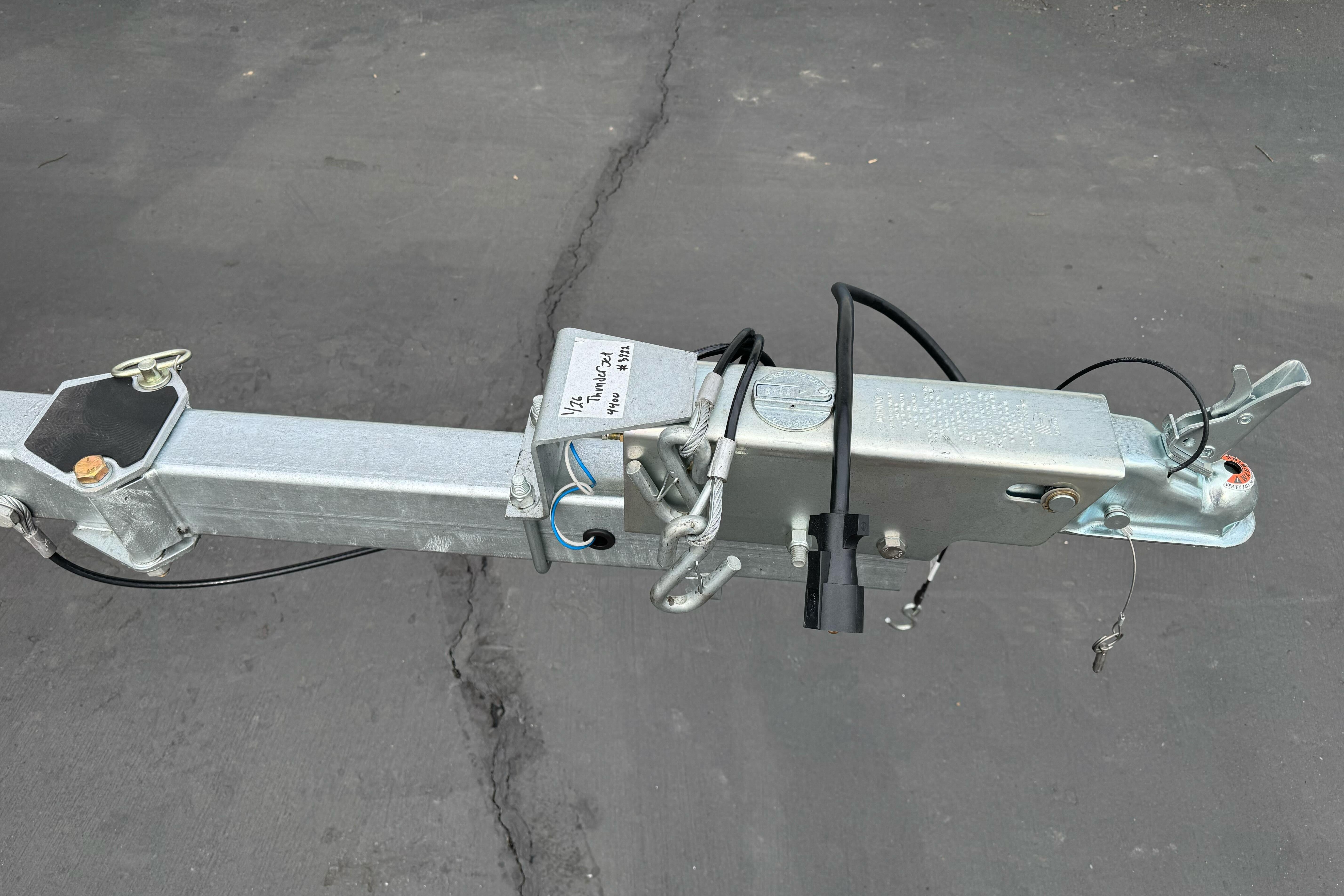 Trailer hitch of 2026 Lund 185 Heavy Gauge boat on asphalt surface.