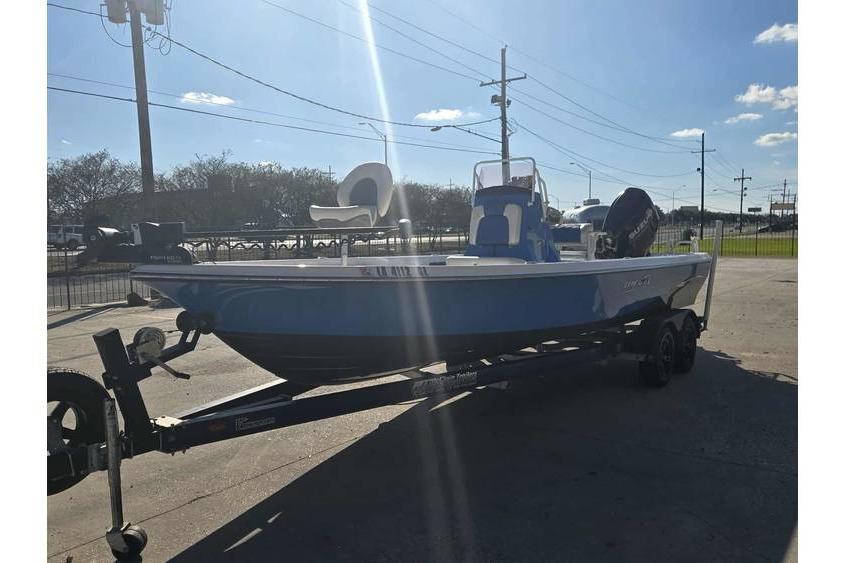 2020 Blue Wave 2400 PureBay boat on trailer under clear sky.
