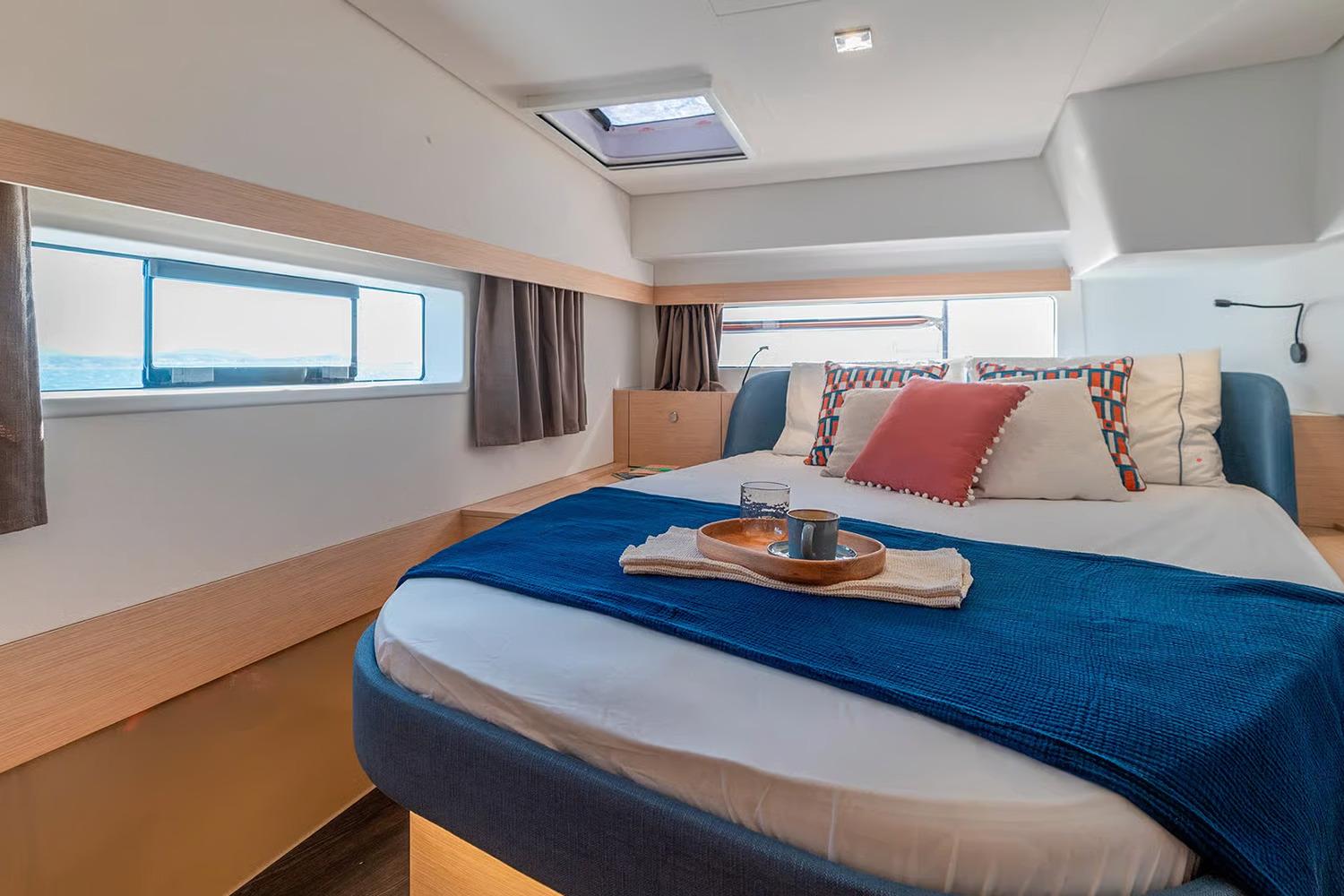 Manufacturer Provided Image: Luxurious bedroom interior of 2026 Fountaine Pajot FP44 Catamaran with modern decor and ocean view.