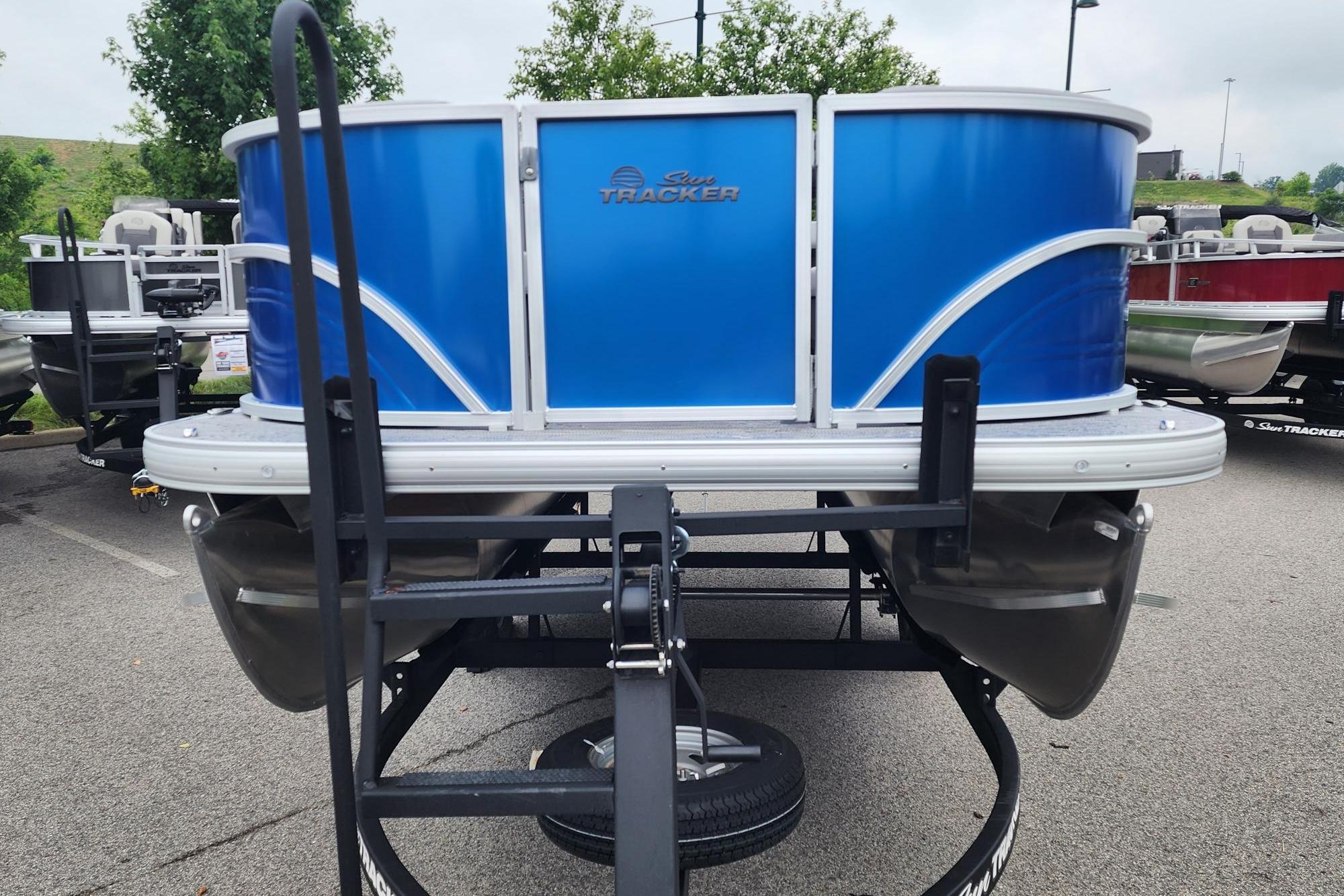 2026 Sun Tracker Party Barge 16 DLX pontoon boat on trailer, front view.