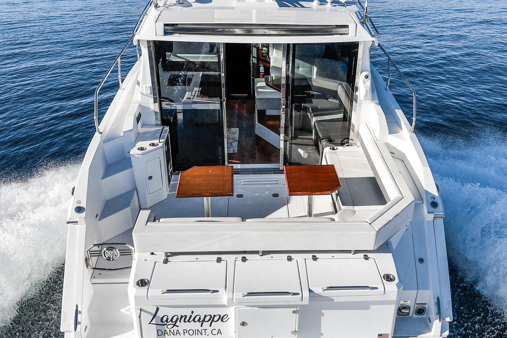 2023 Cruisers Yachts 42 Cantius cruising on open water, rear view.